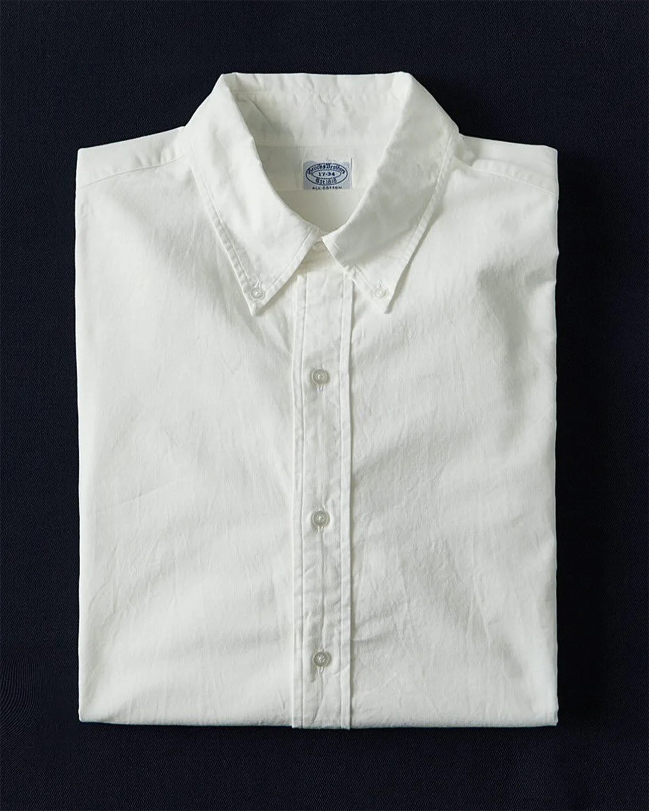 a folded white oxford shirt