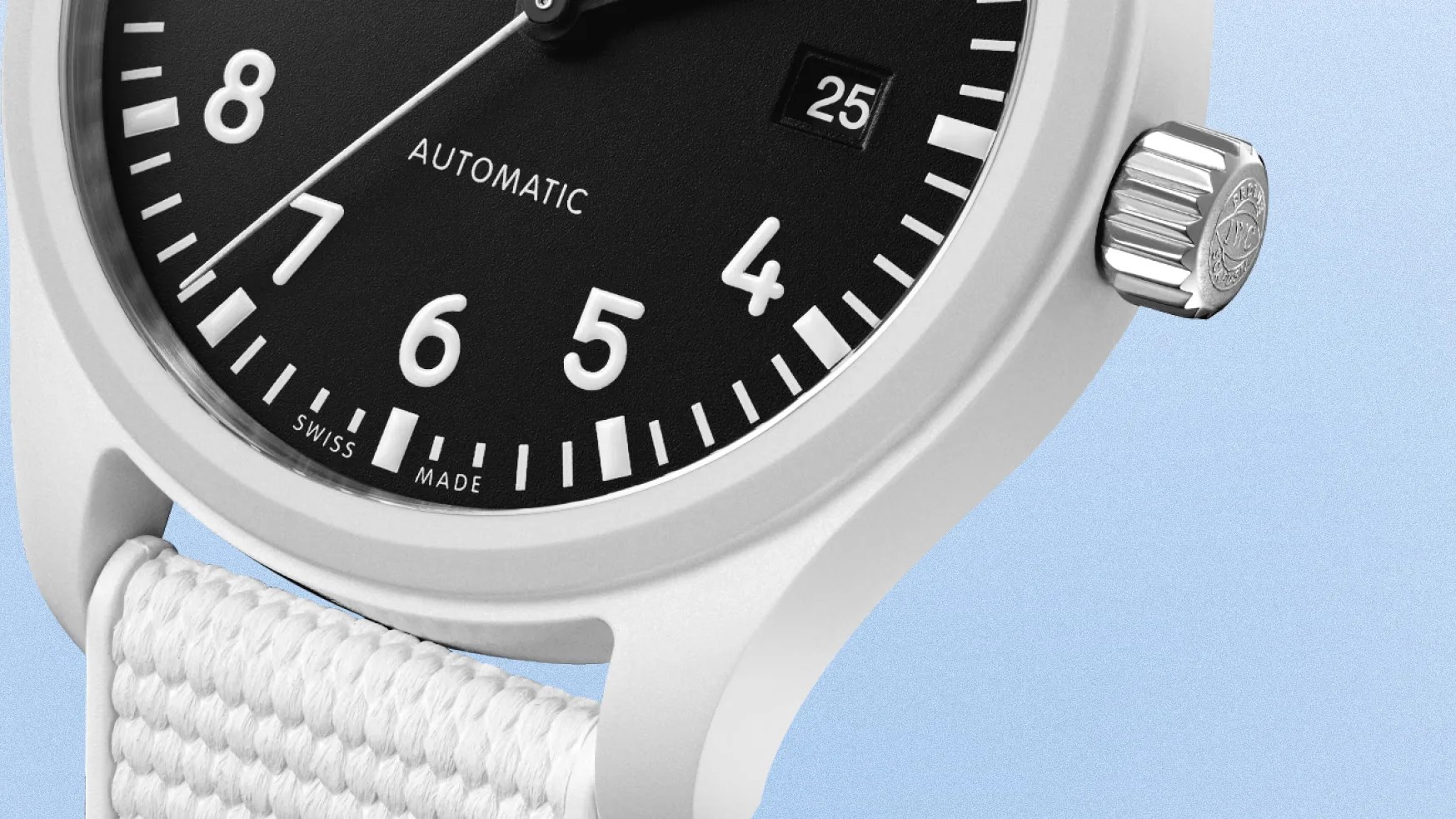 close up of a white watch with a black dial