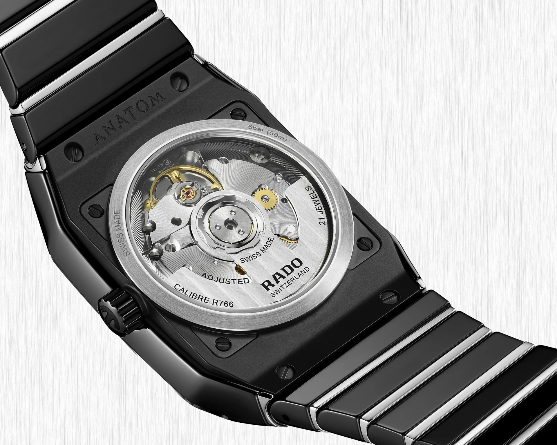 the exhibition case back of a black ceramic watch