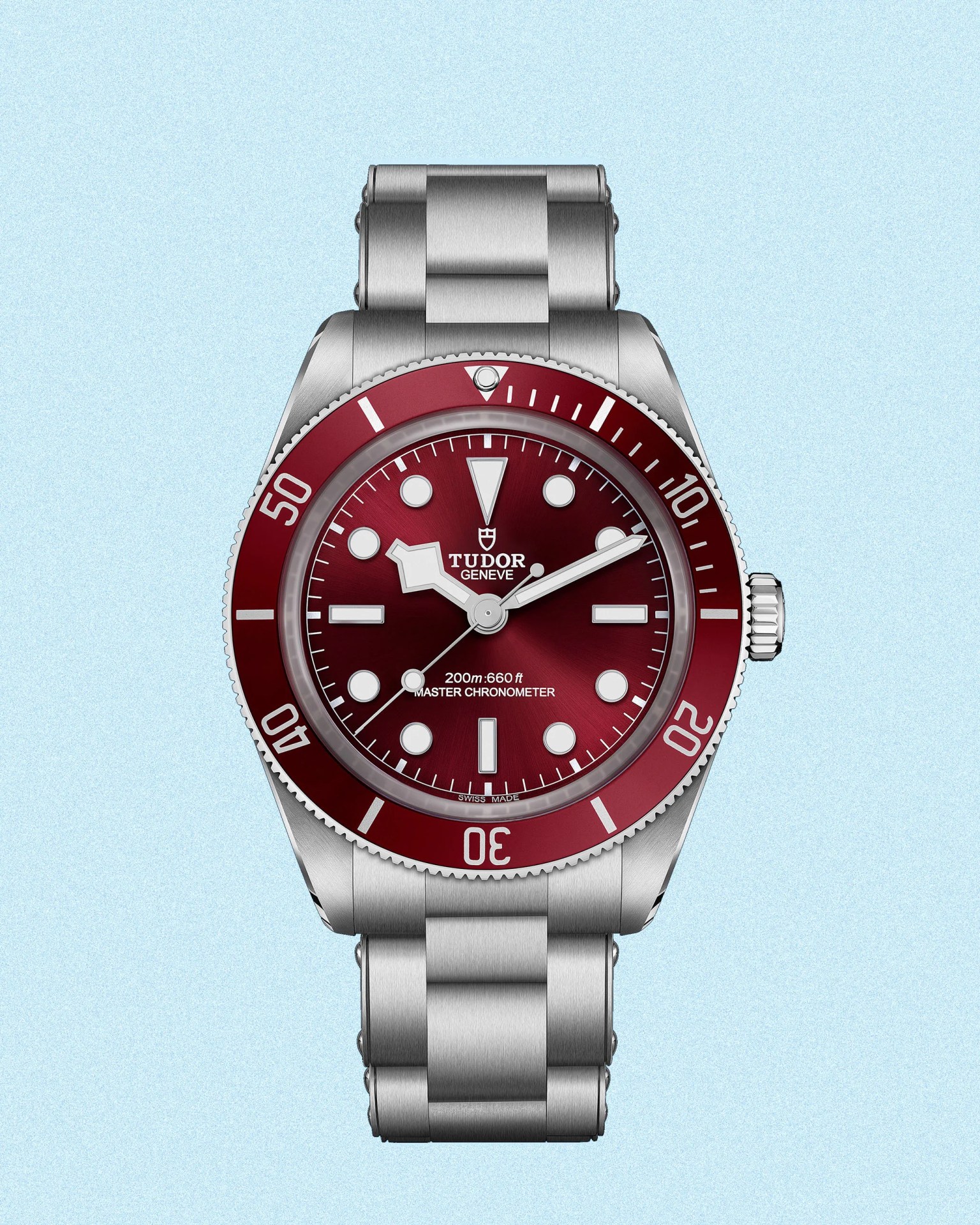 a Tudor dive watch with a red dial and bezel