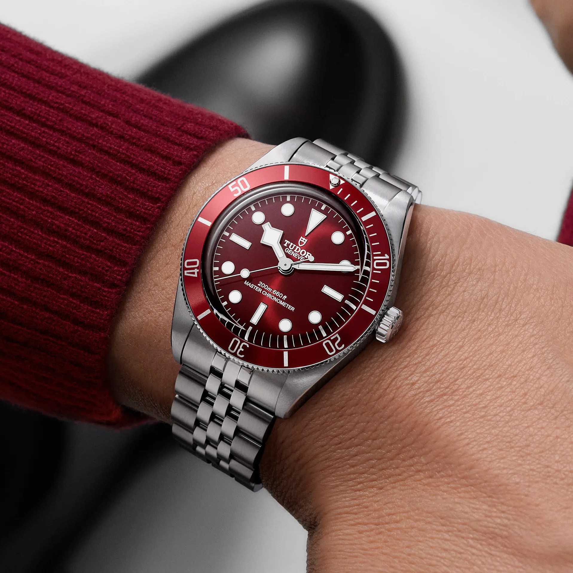 a steel dive watch on a man's wrist