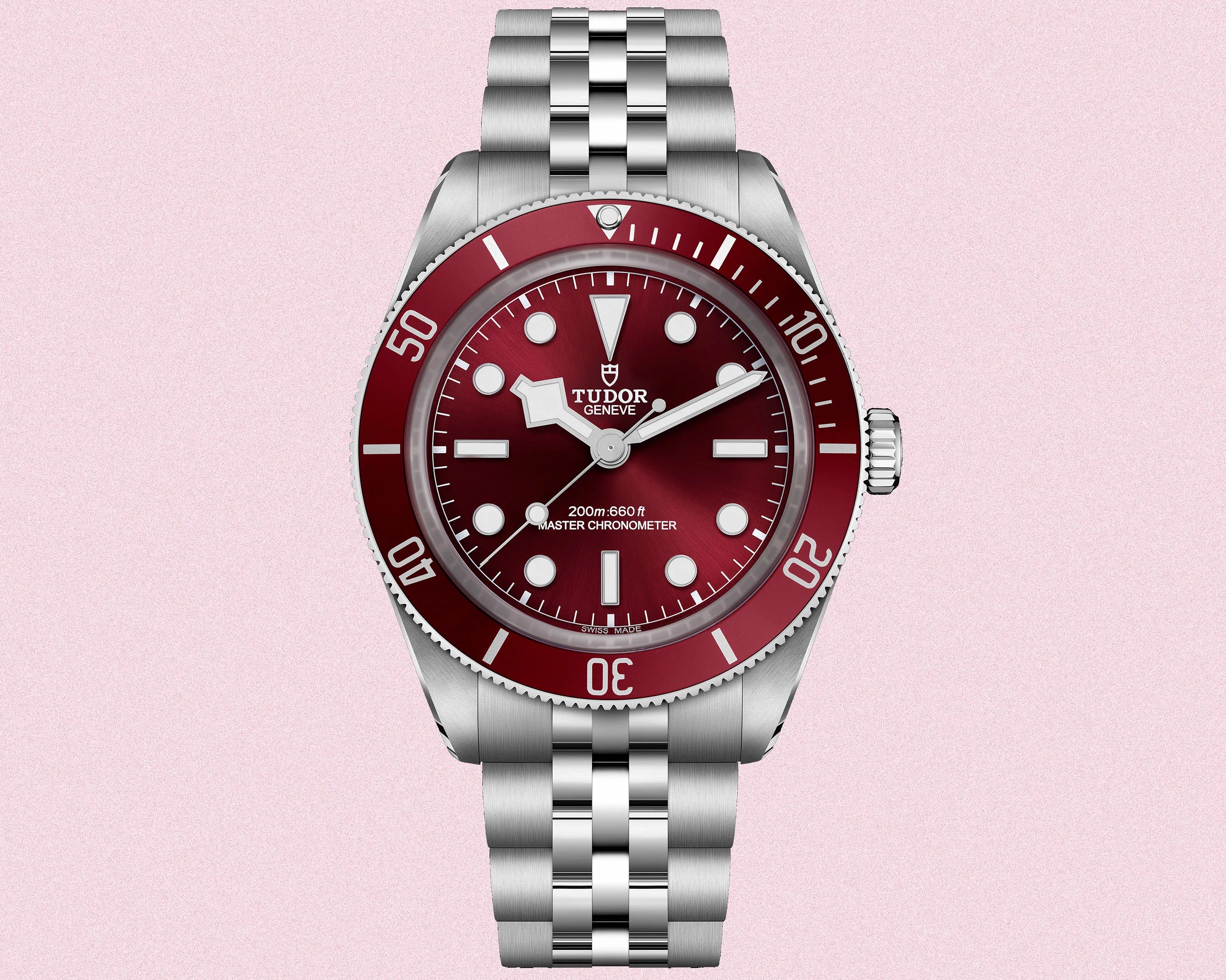 a steel dive watch with a red dial