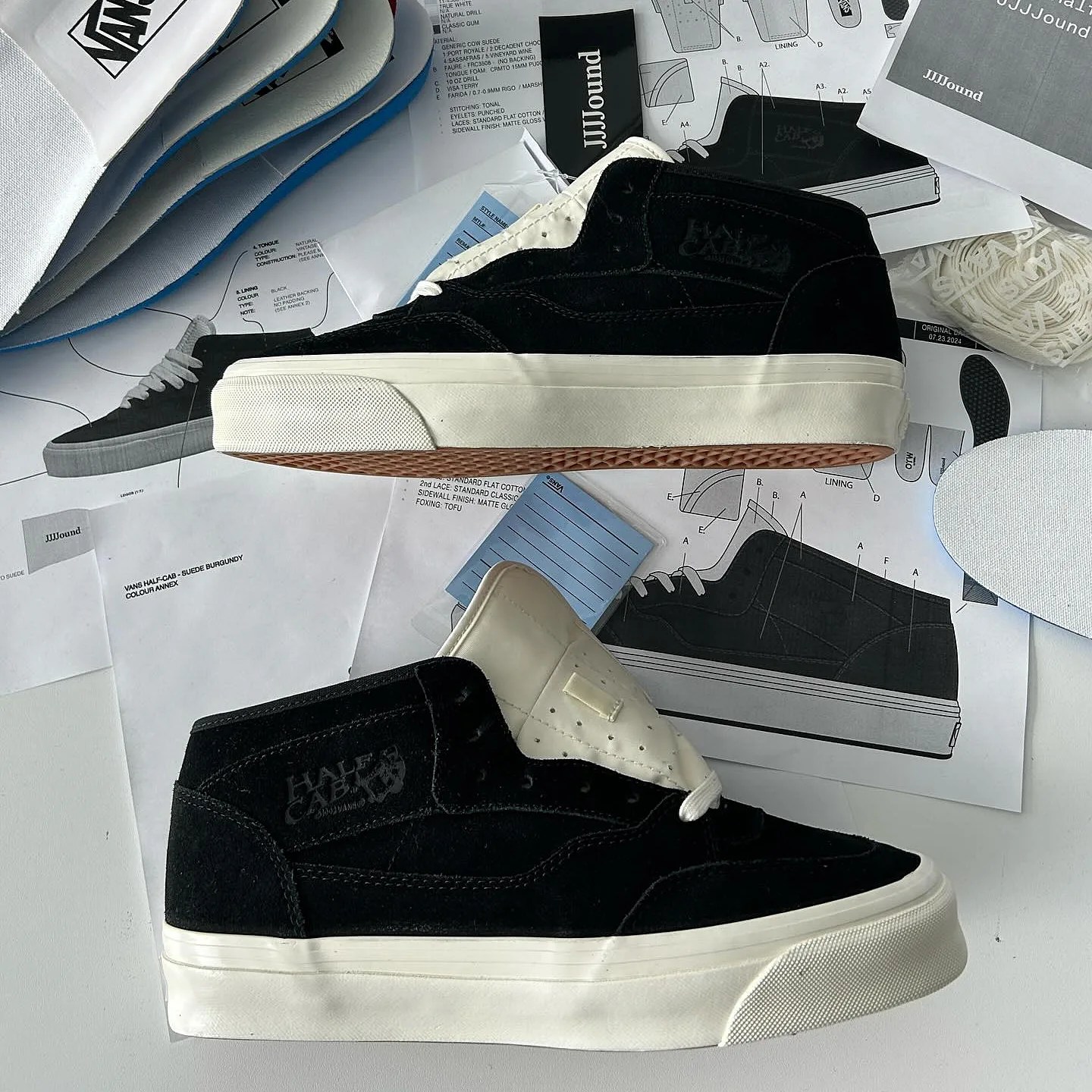 a pair of black sneakers on a desk