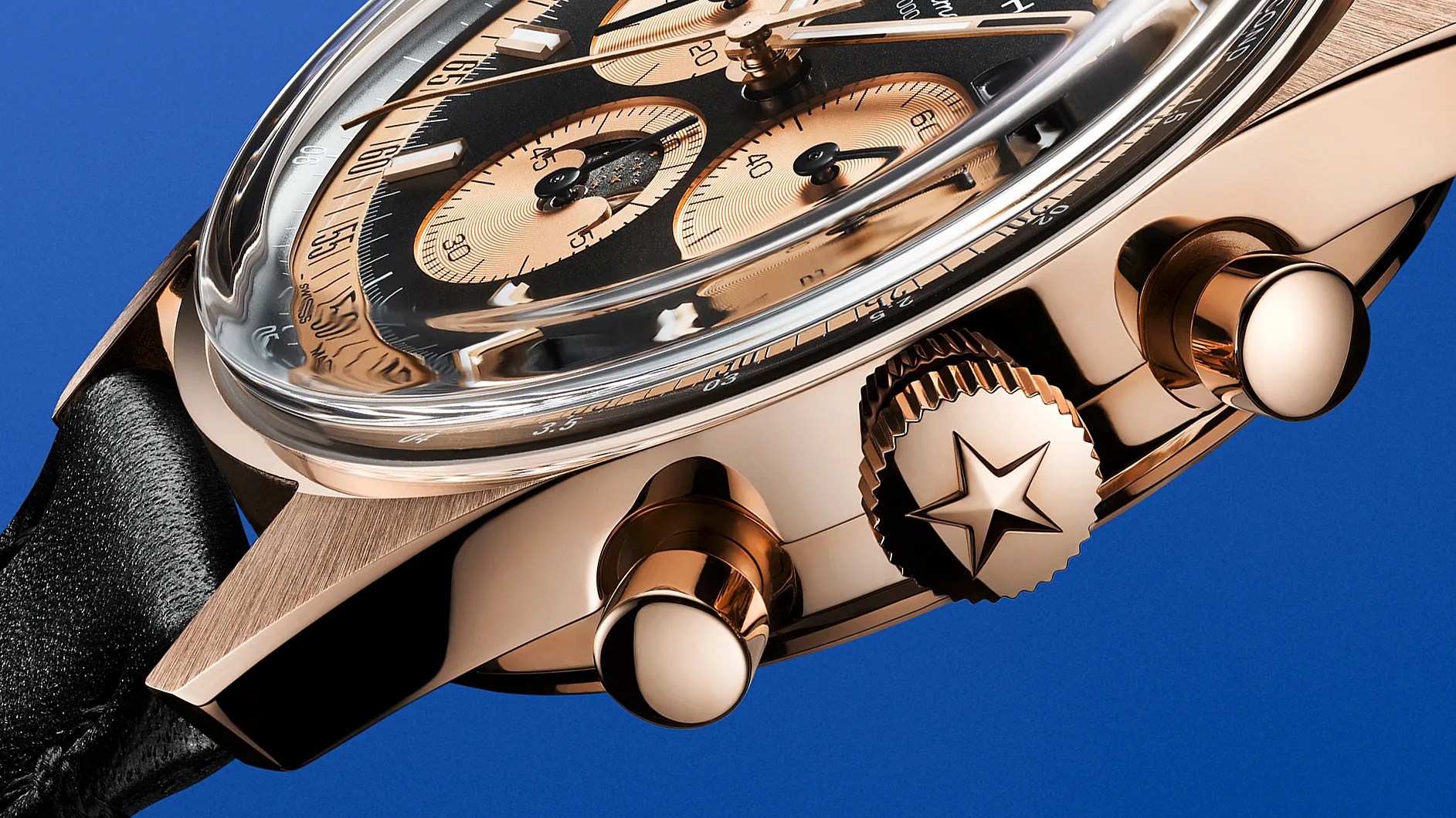 the crown and case of a rose gold watch