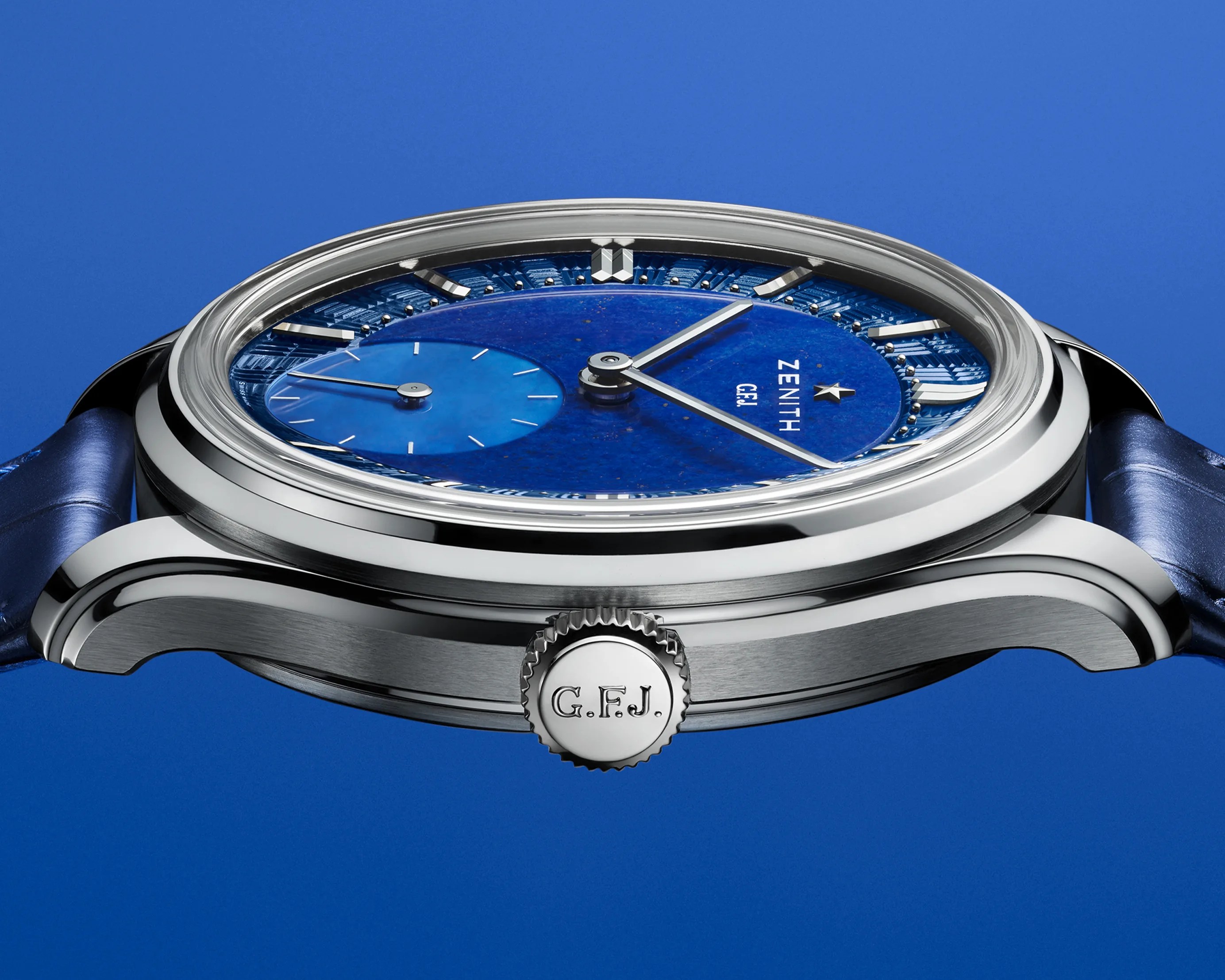 the side and crown of a Zenith watch with a blue dial