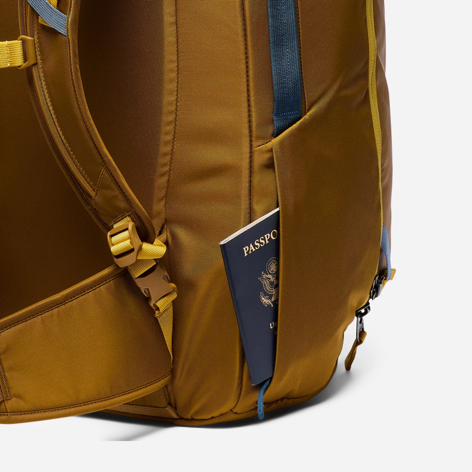 The Cotopaxi Allpa 50L Adventure Travel Pack's hidden passport pocket shown with a US passport shown peaking out of it
