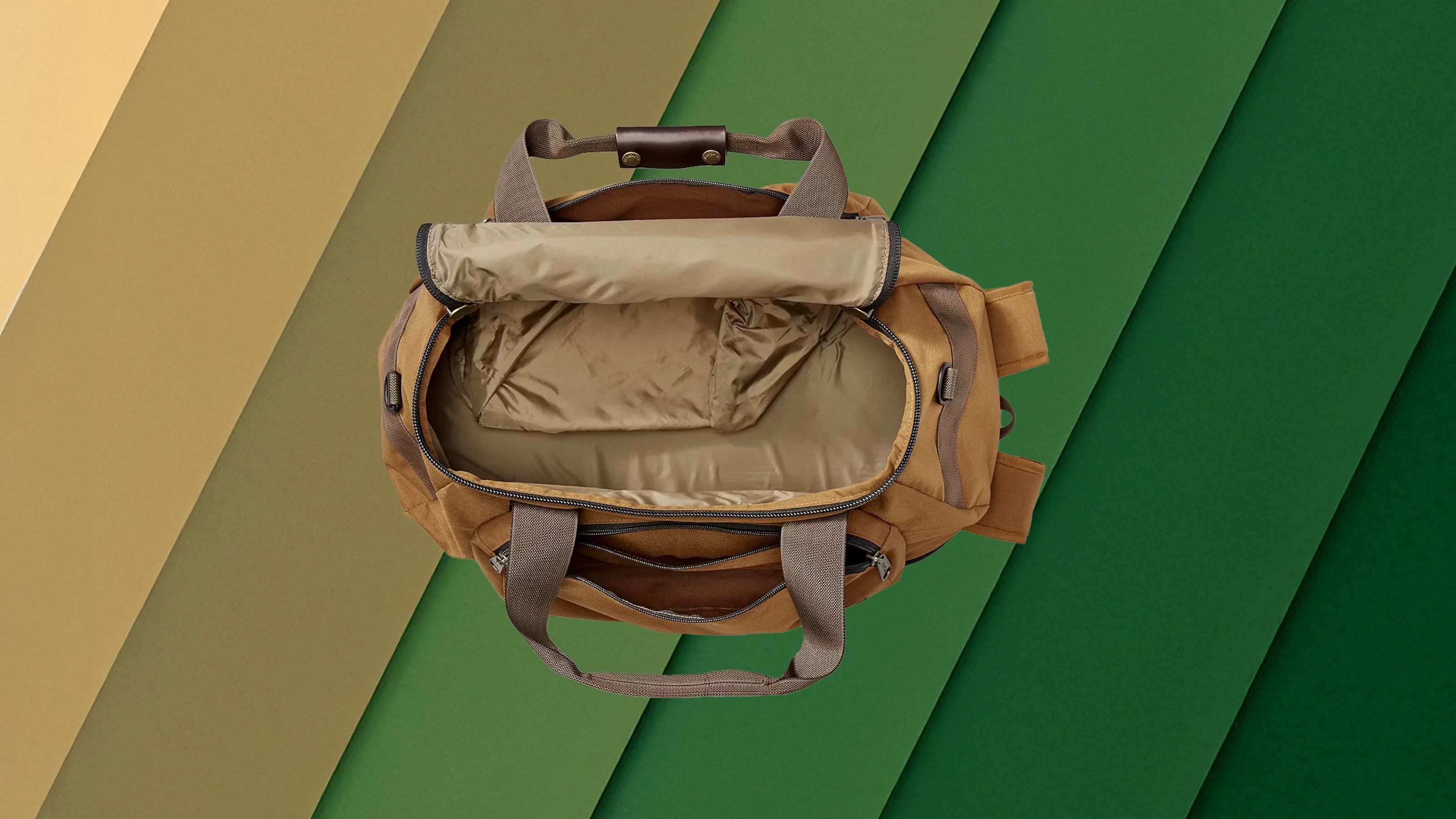Filson Duffel Backpack Hybrid against a gradient background of tans and green