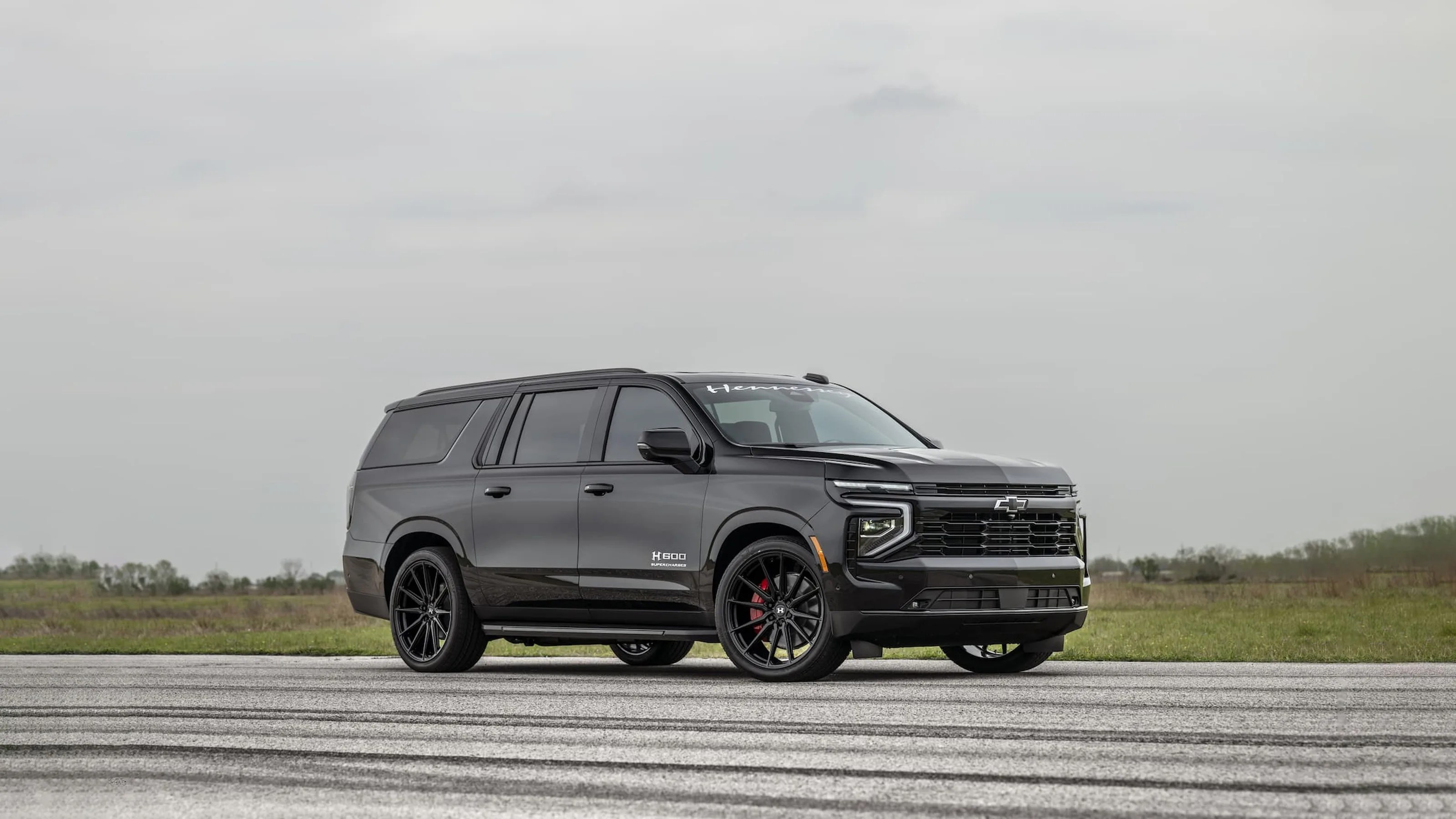 Hennessey Performance H600 Suburban in black shown driving on asphalt pointing to the right