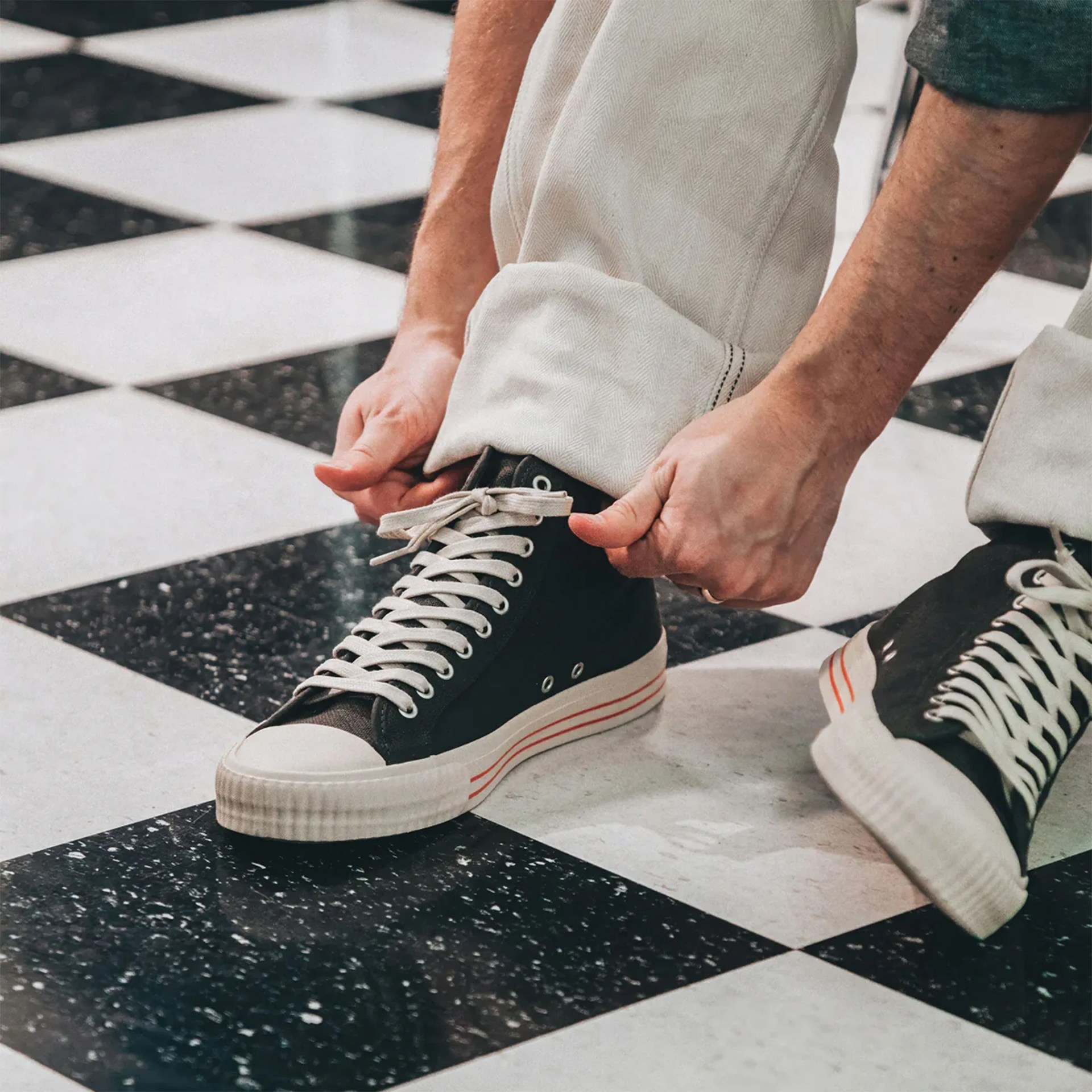 PF Flyers The Captain Sneaker on tile floor worn by model