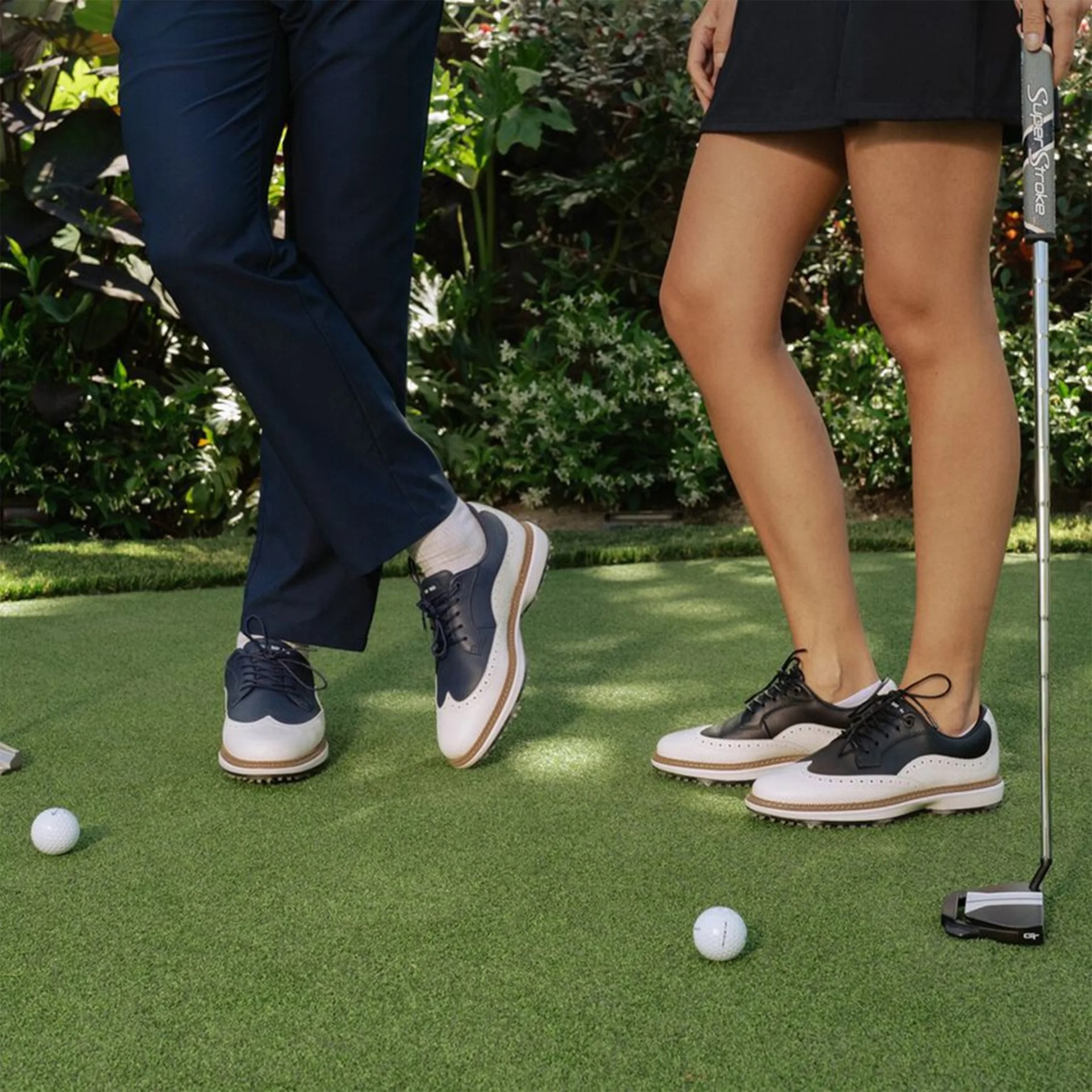 Sun Day Red Pioneer Magnolia golf shoe worn by two models on putting green