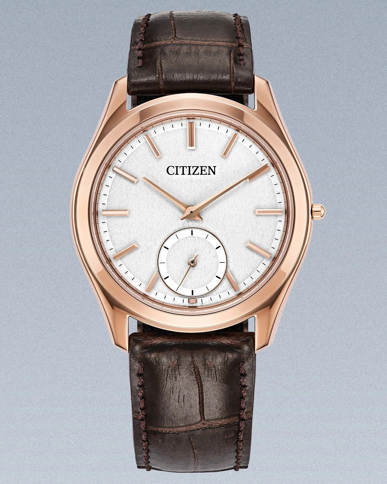 a gold Citizen dress watch with a white dial