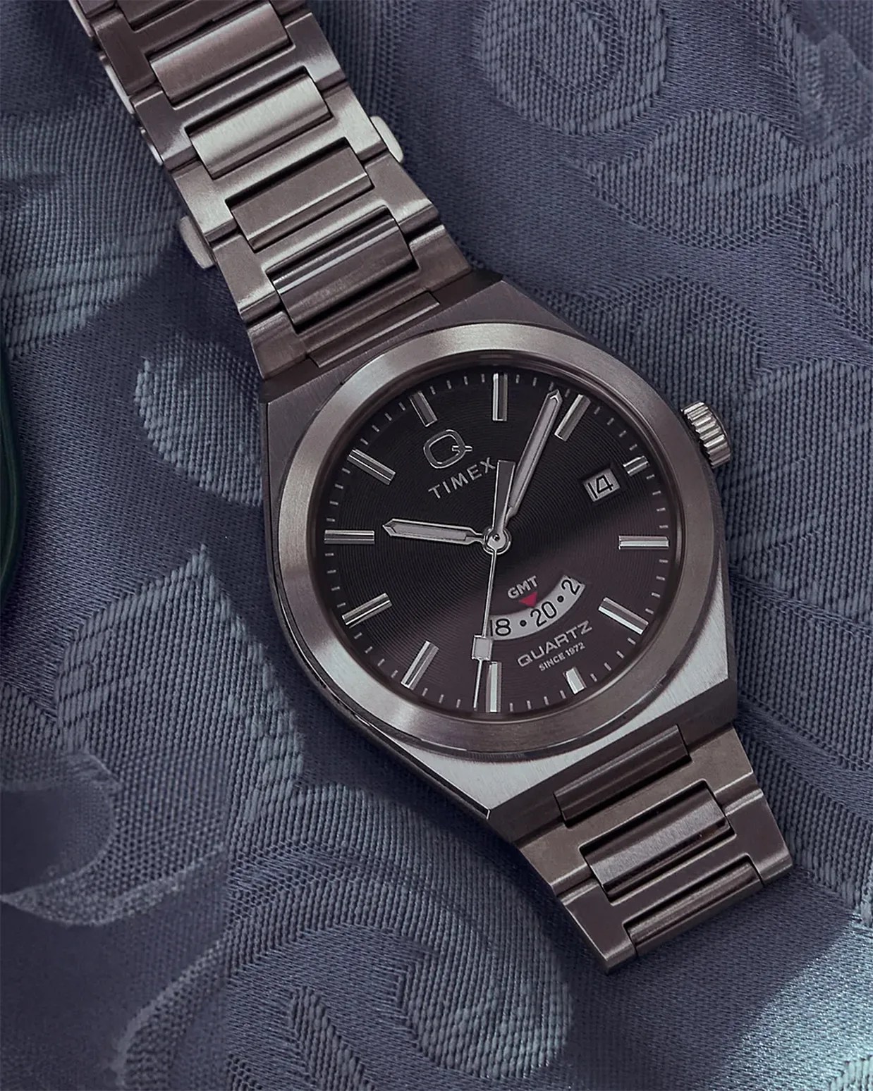 a steel Q Timex GMT watch