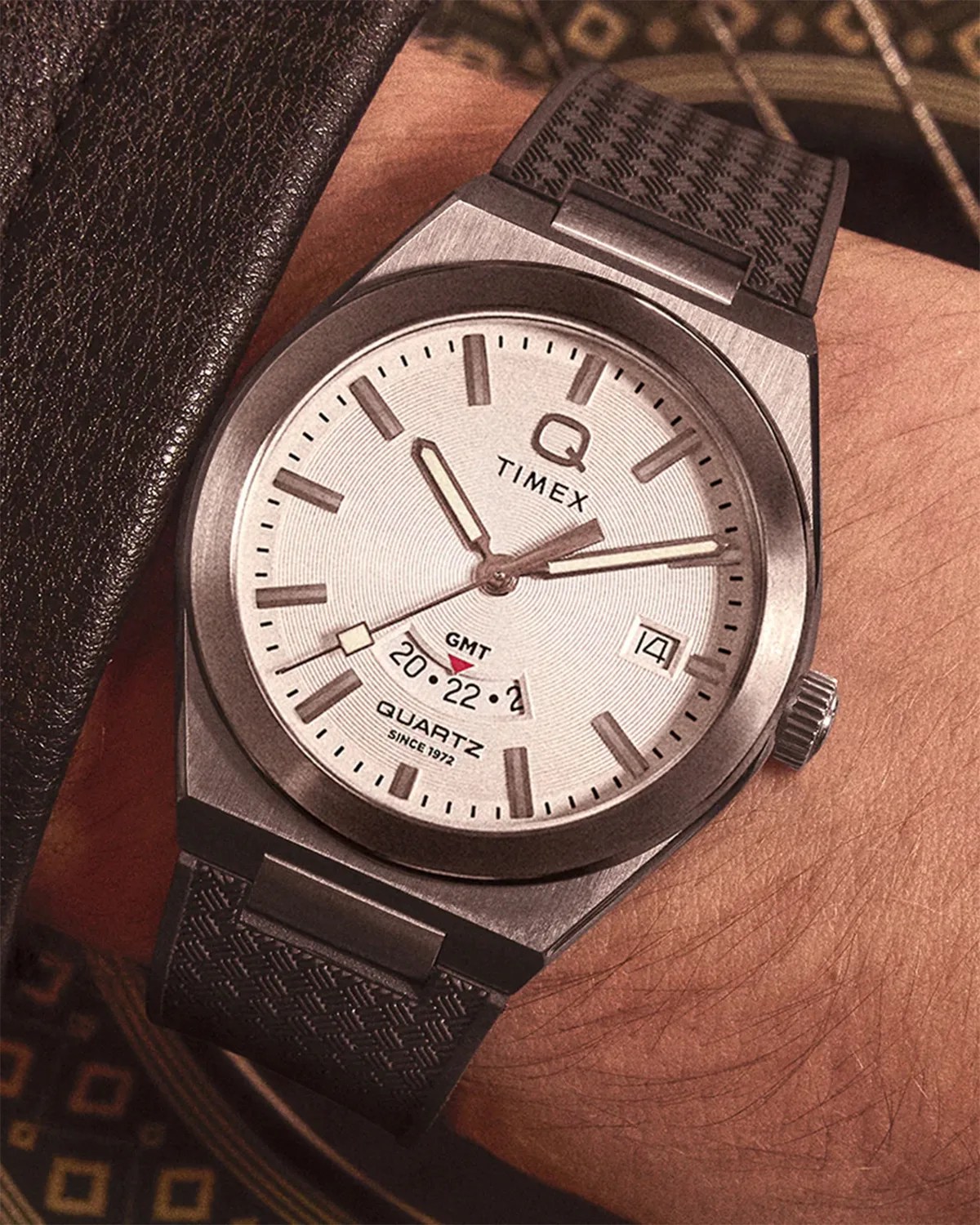 a Q timex watch on a man's wrist