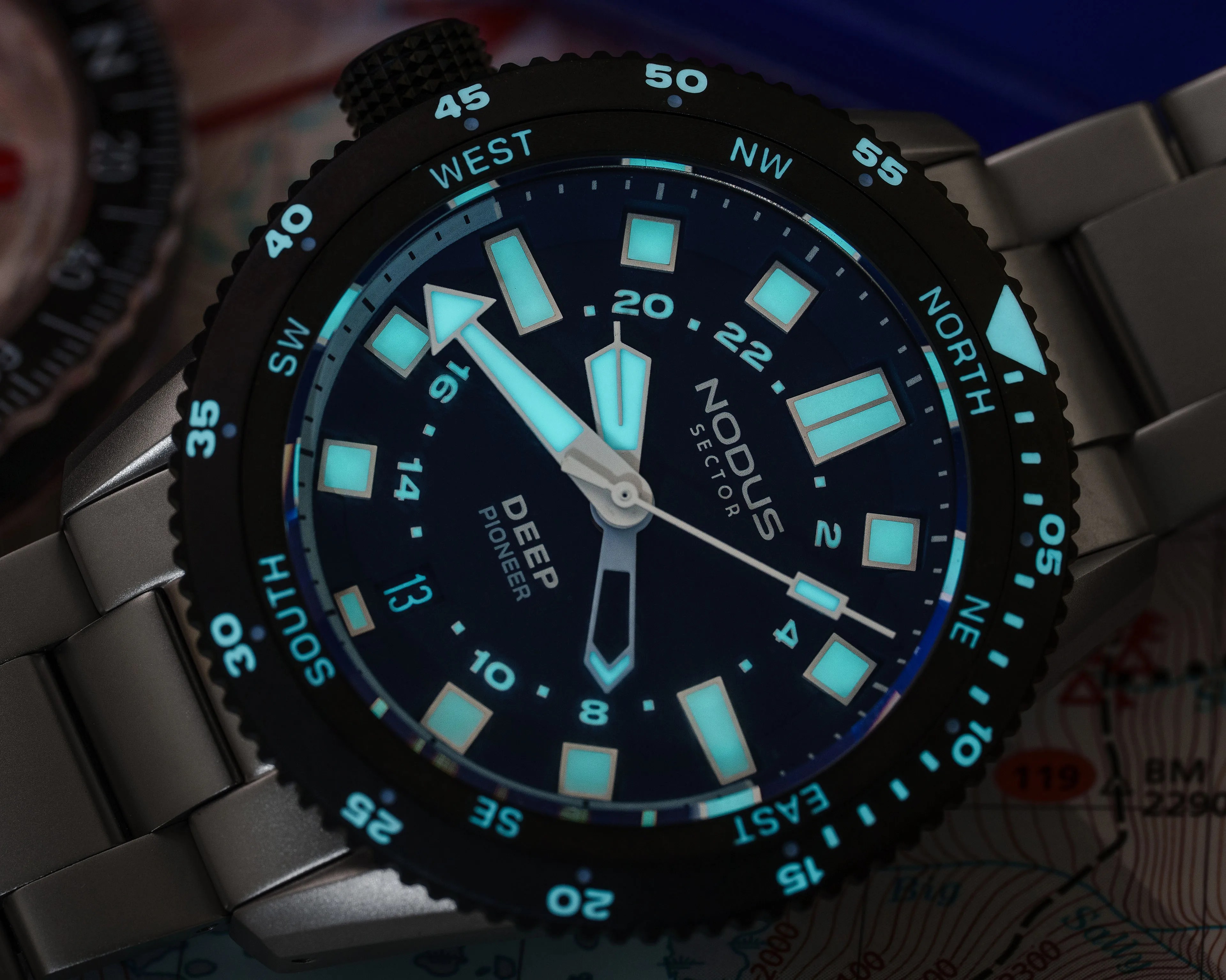 the lume of a Nodus watch glowing in the dark