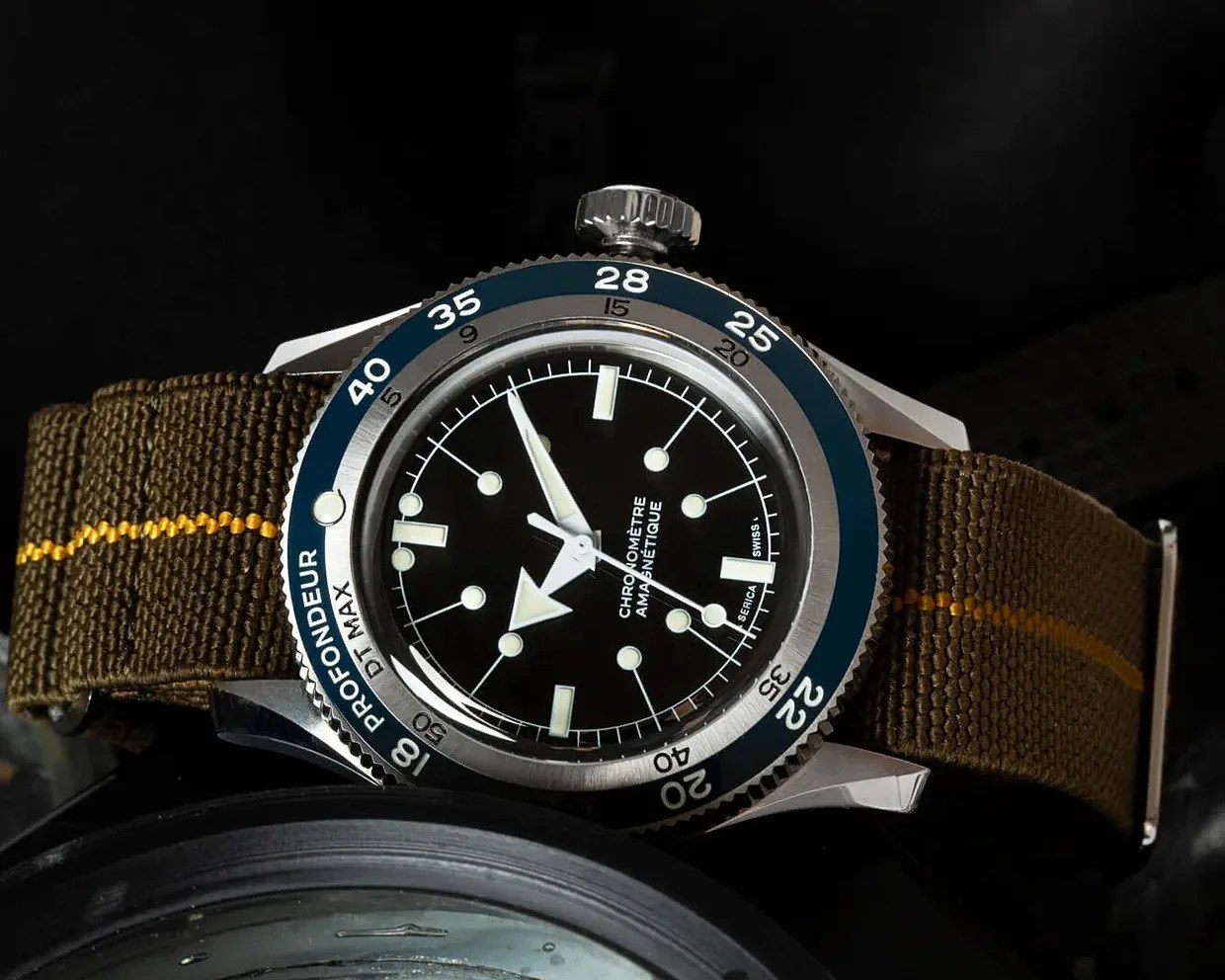 a Serica dive watch with a green strap