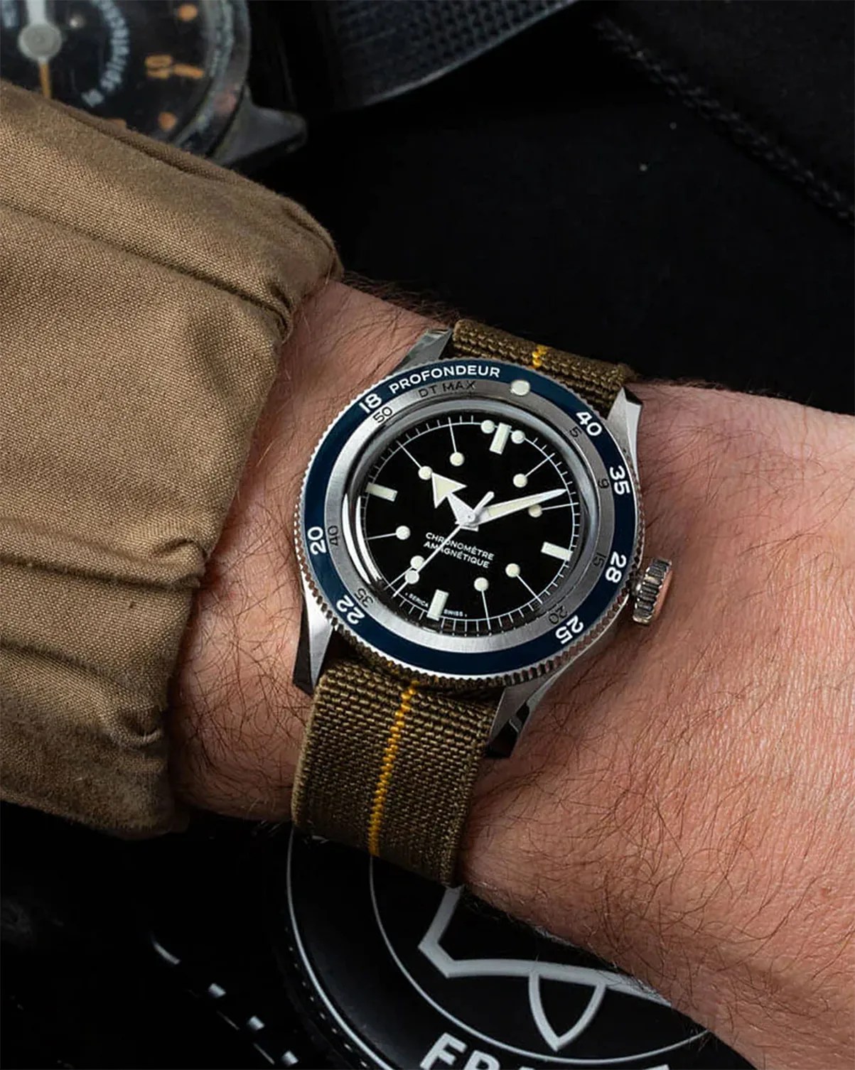 a Serica dive watch on a man's wrist