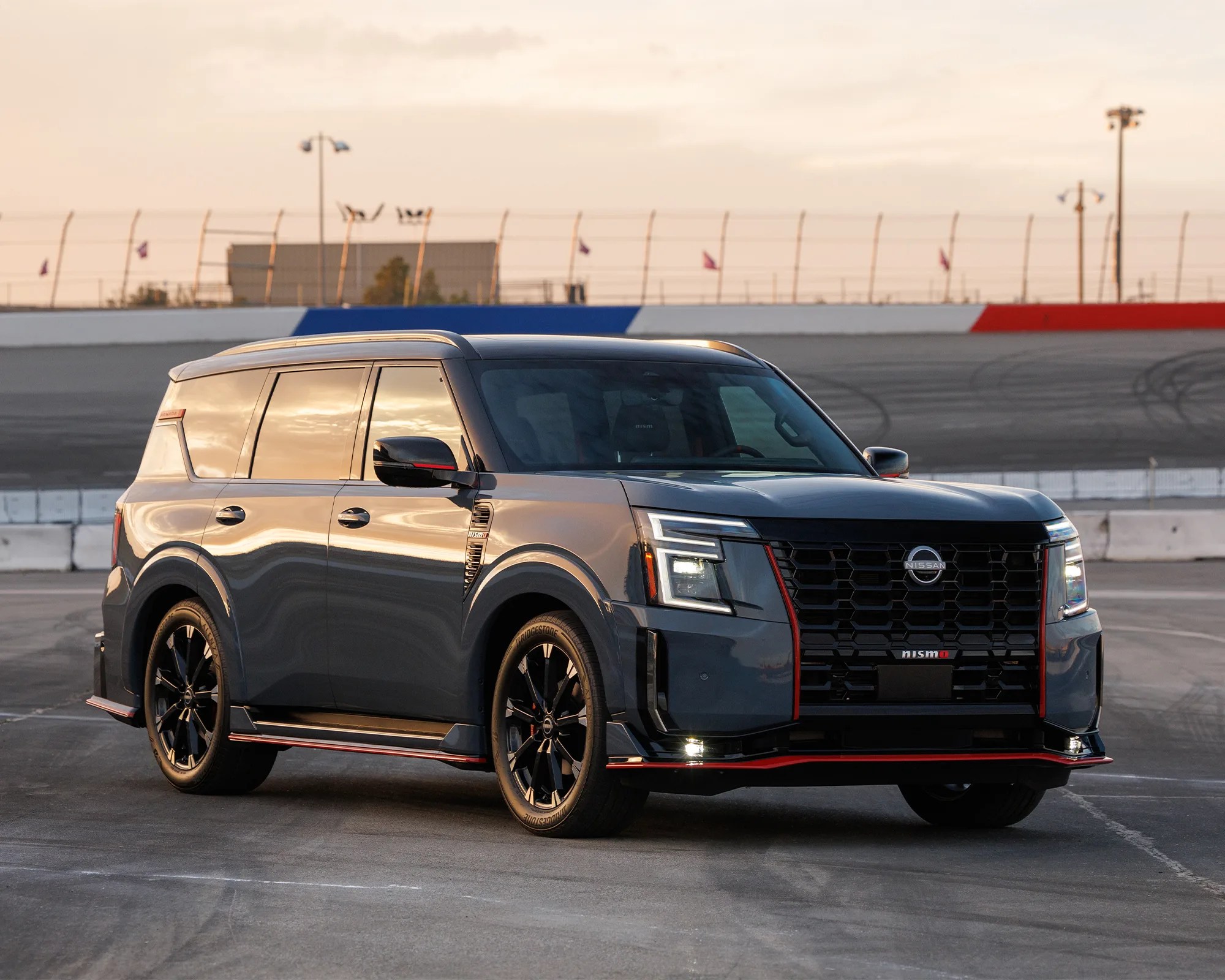 2026 Nissan Armada Nismo SUV on racetrack at sunset