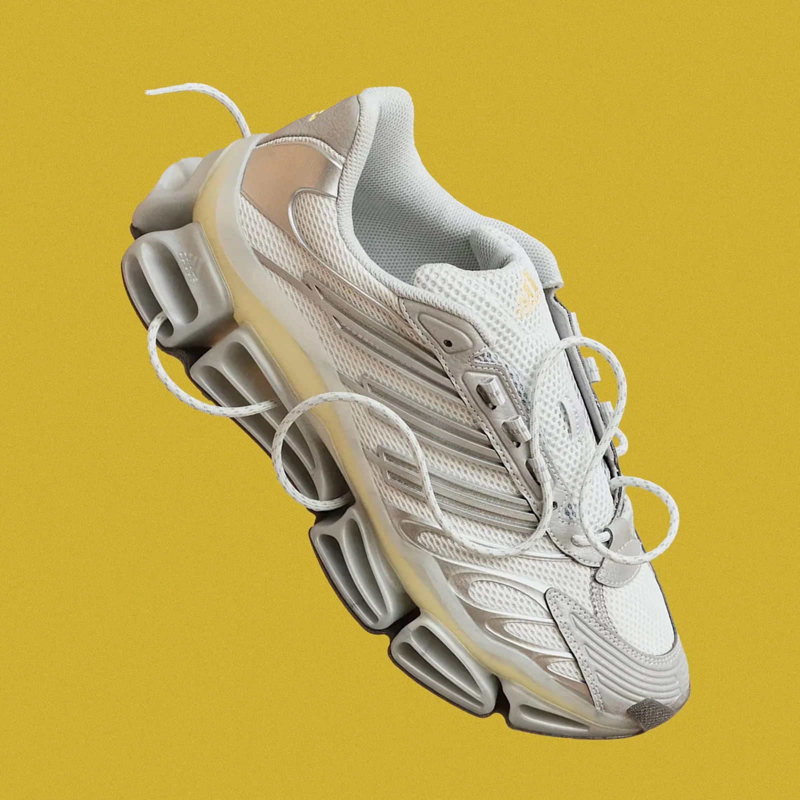 The Adidas Megarise AG shown in full against a speckled yellow background.