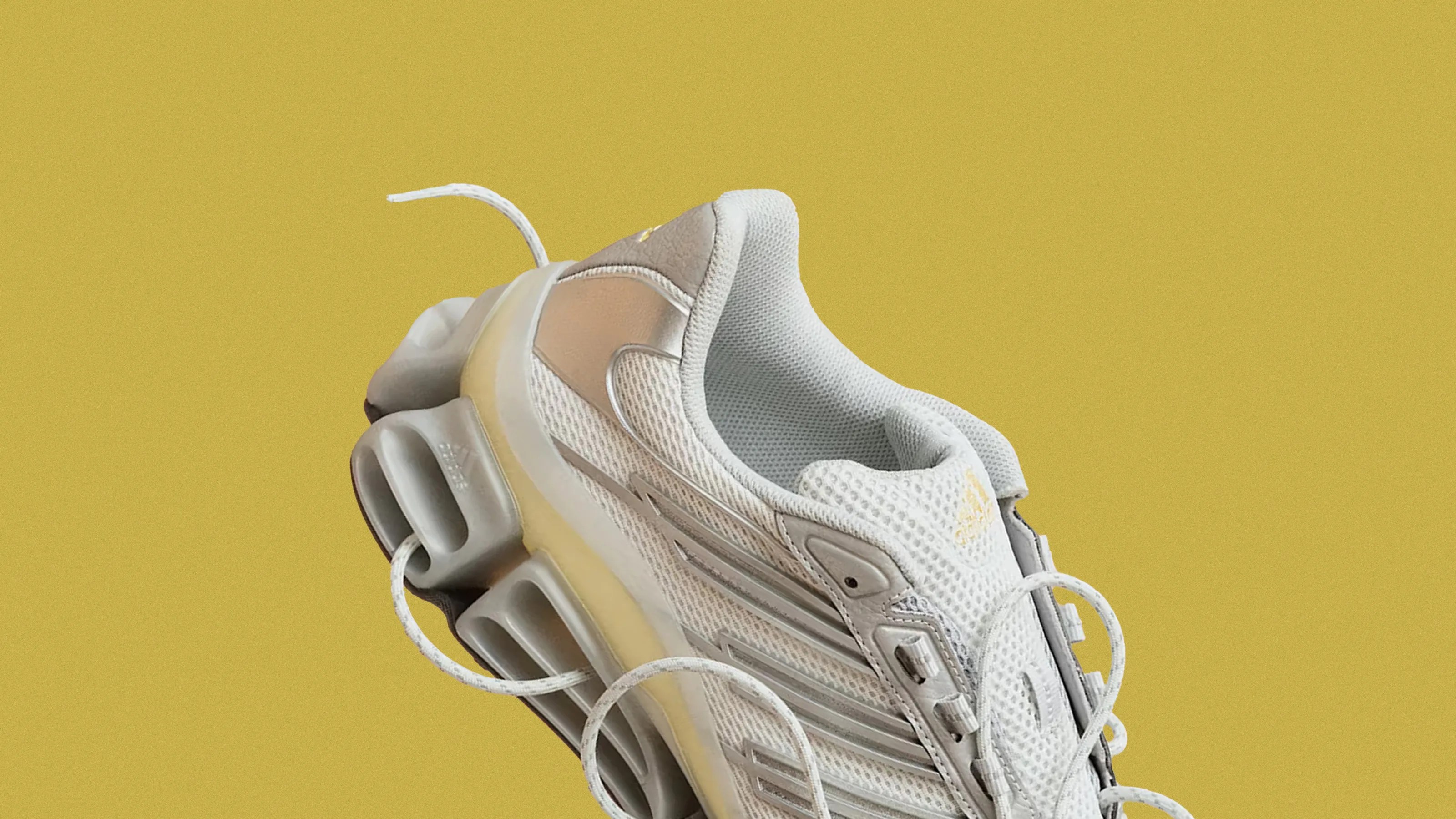 An angled view of the The Adidas Megarise AG shown against a speckled yellow background.