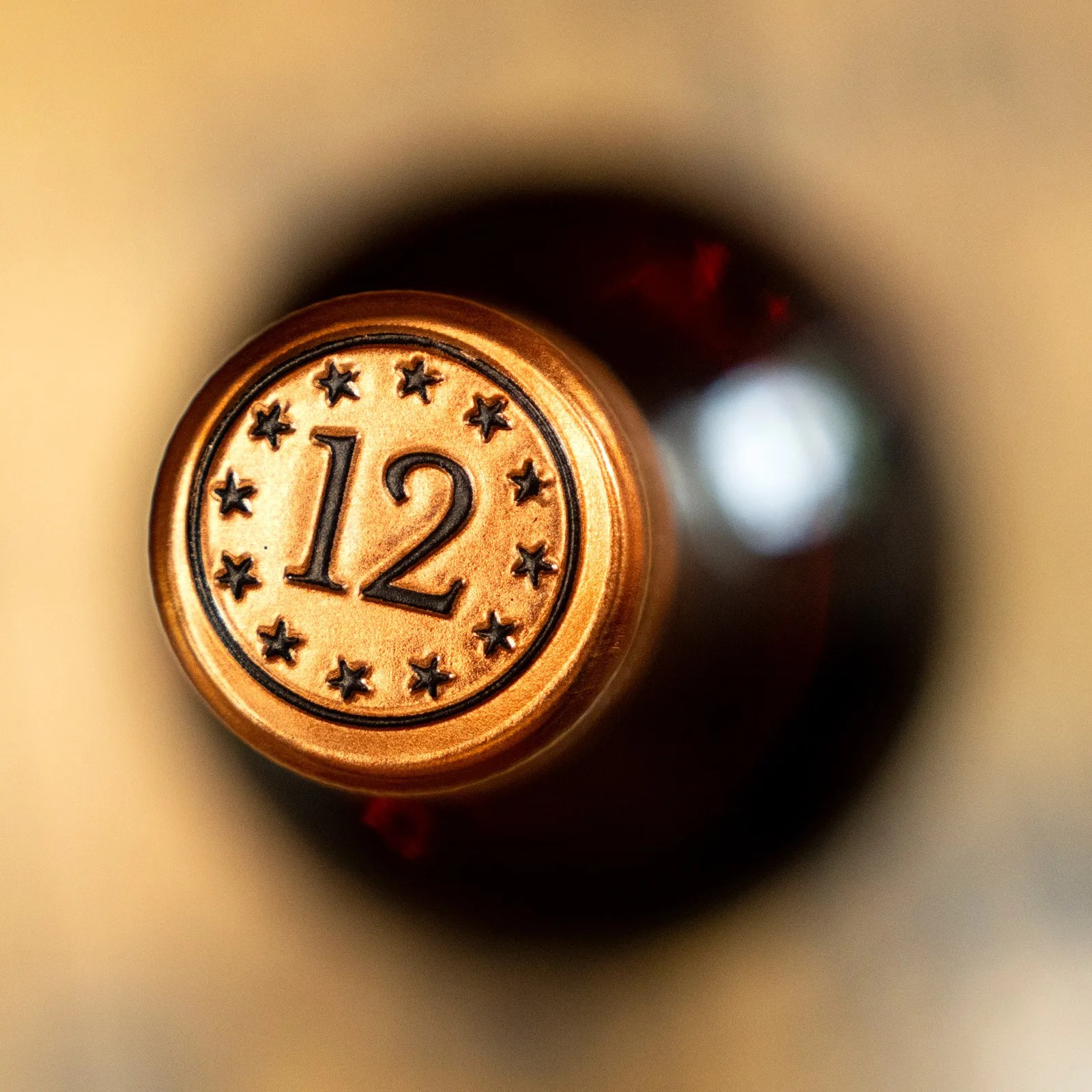 A few of the top of a bottle of Eagle Rare 12 with a heavily blurred background.