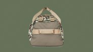 Filson All-Weather 50L Duffle Bag in Shrub Camo against a dark green background