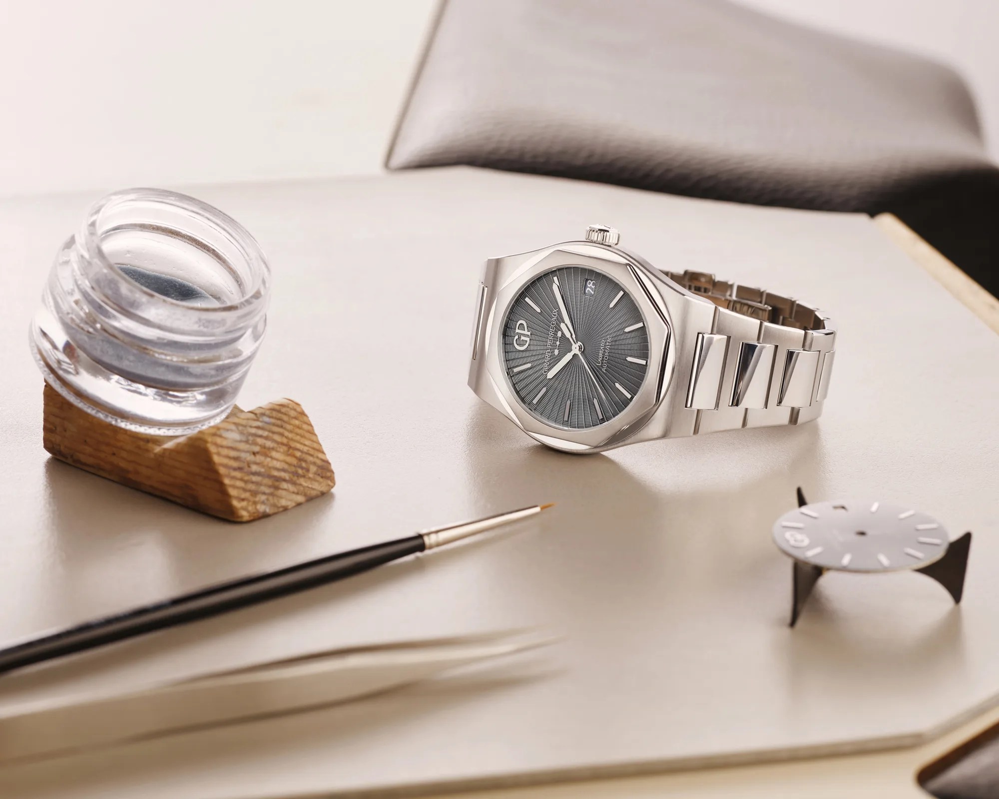 Girard-Perregaux Laureato Grey Enamel Flinque Sunray Sport Watch on table with paintbrush and enamel