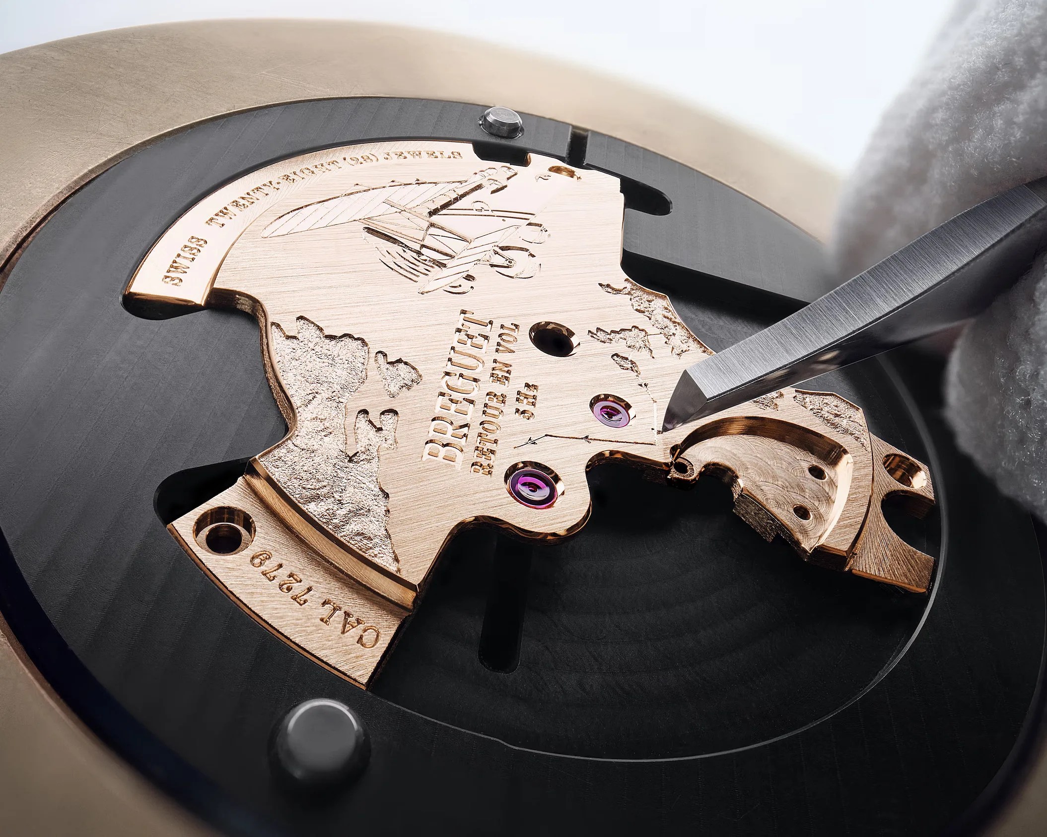 a Breguet watch part being hand-engraved