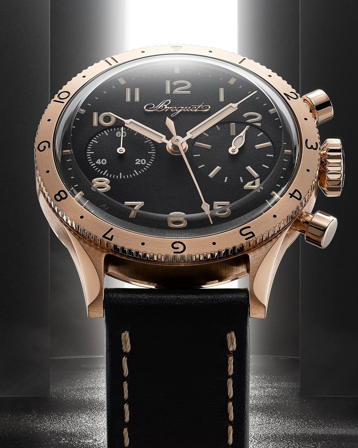 a gold Breguet watch with a balck dial