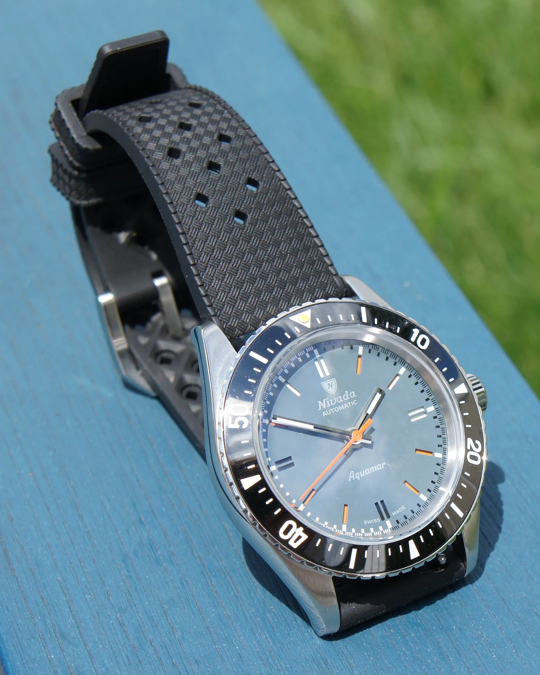 a Nivada dive watch with a blue dial