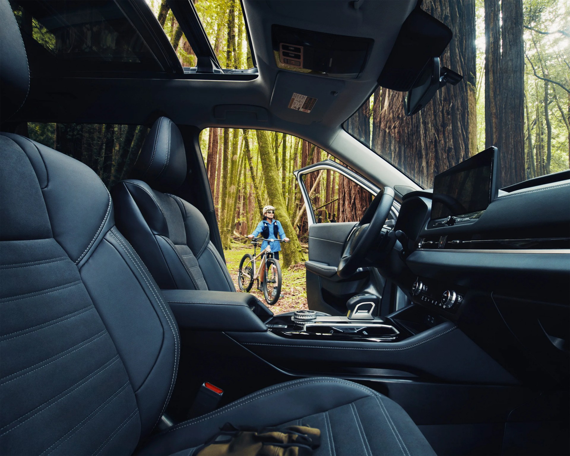 a photo of a mountain biker shown through the interior of a mitsubishi outlander
