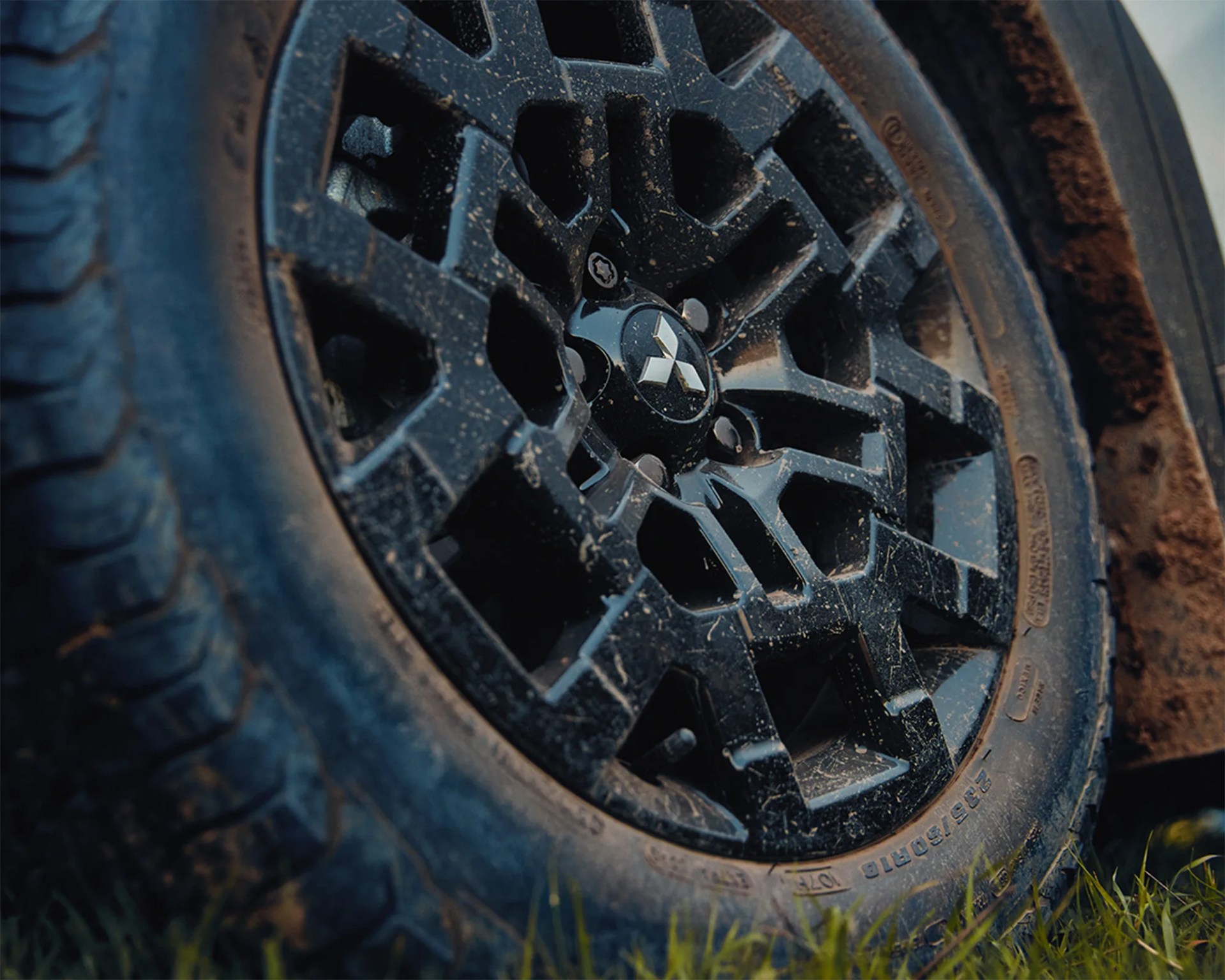 a close-up photo of a black mitsubishi wheel