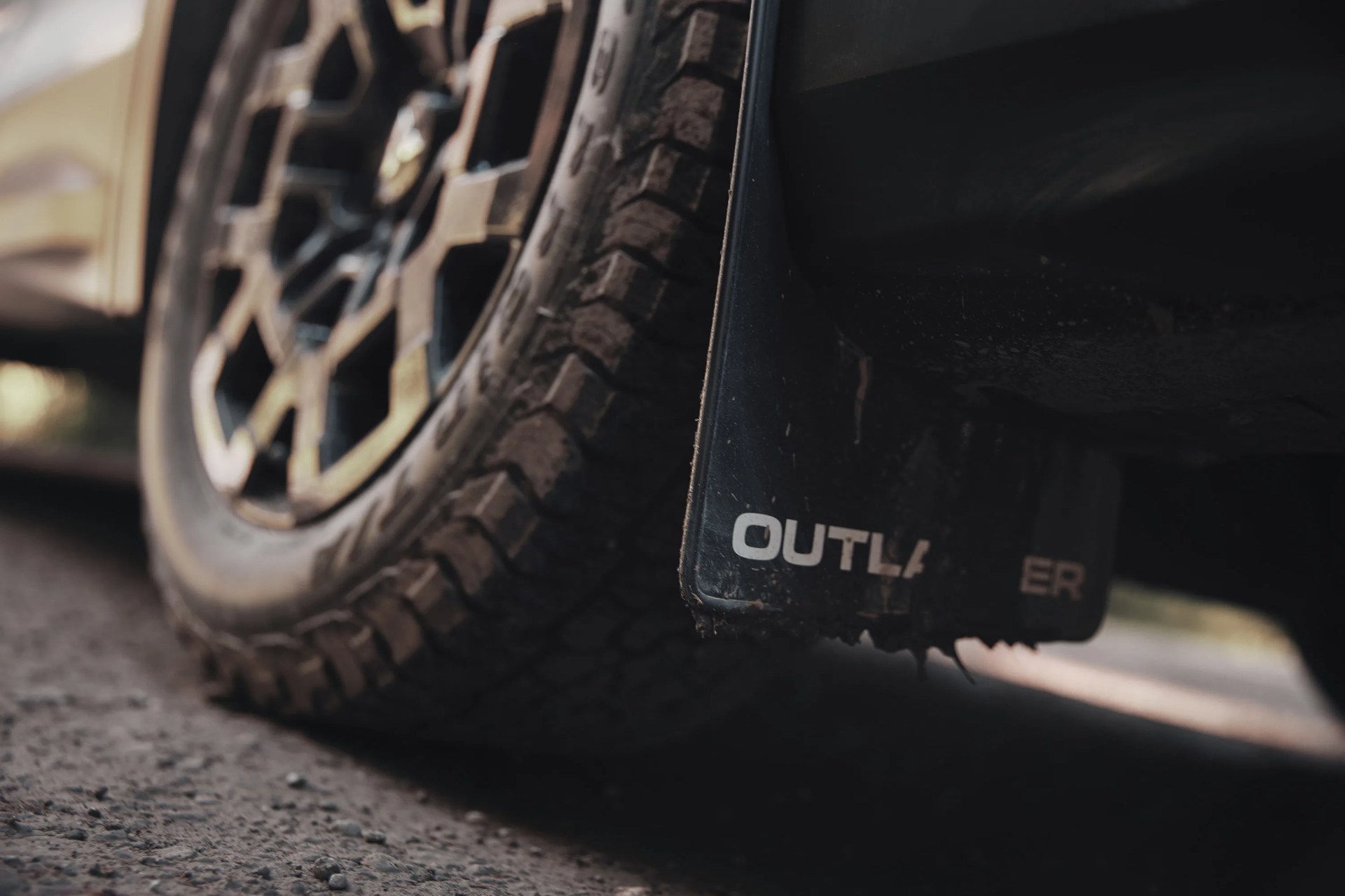 a close-up photo of a mitsubishi mud flap