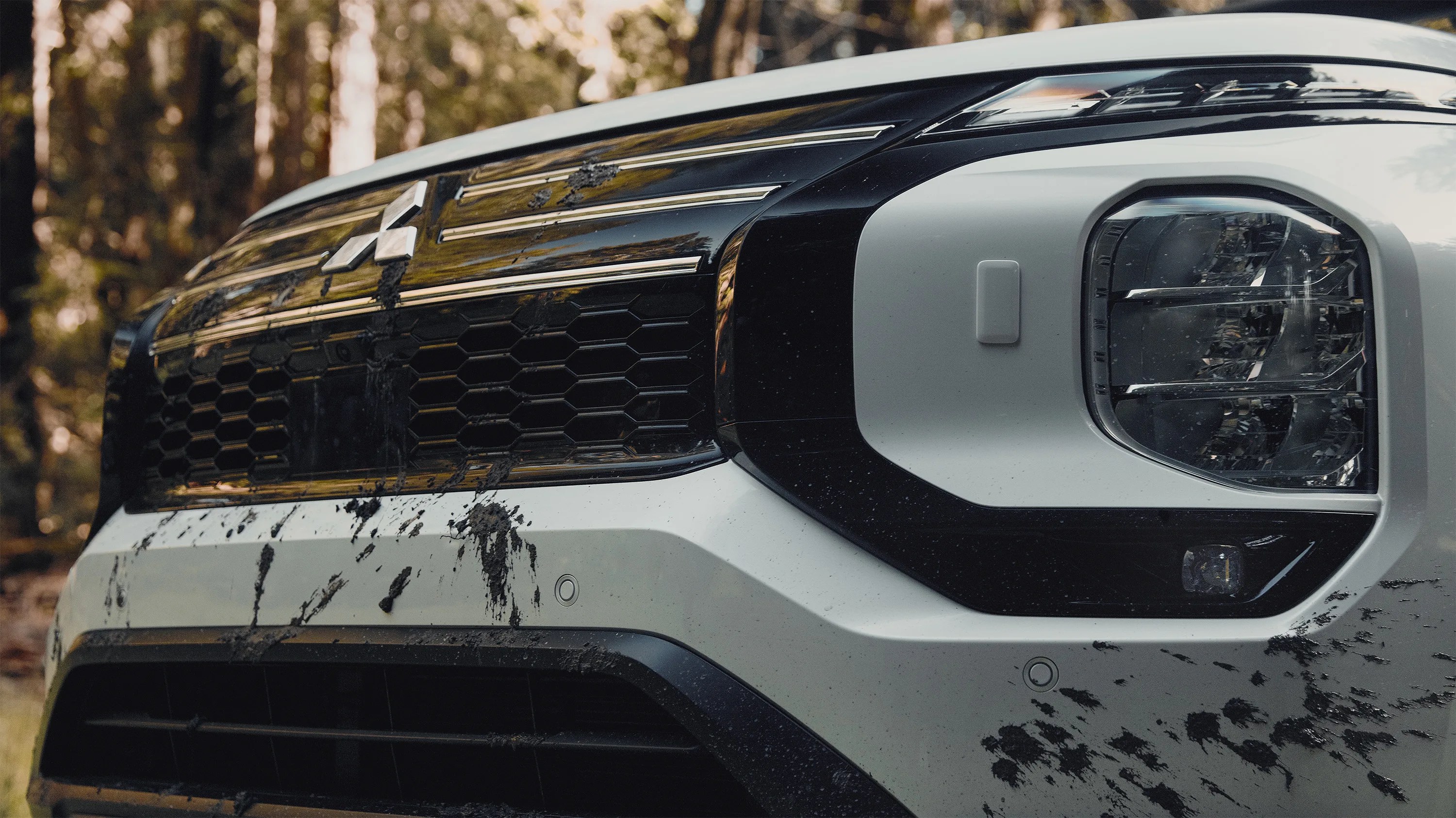 a close-up photo of the front grille of a mitsubishi outlander