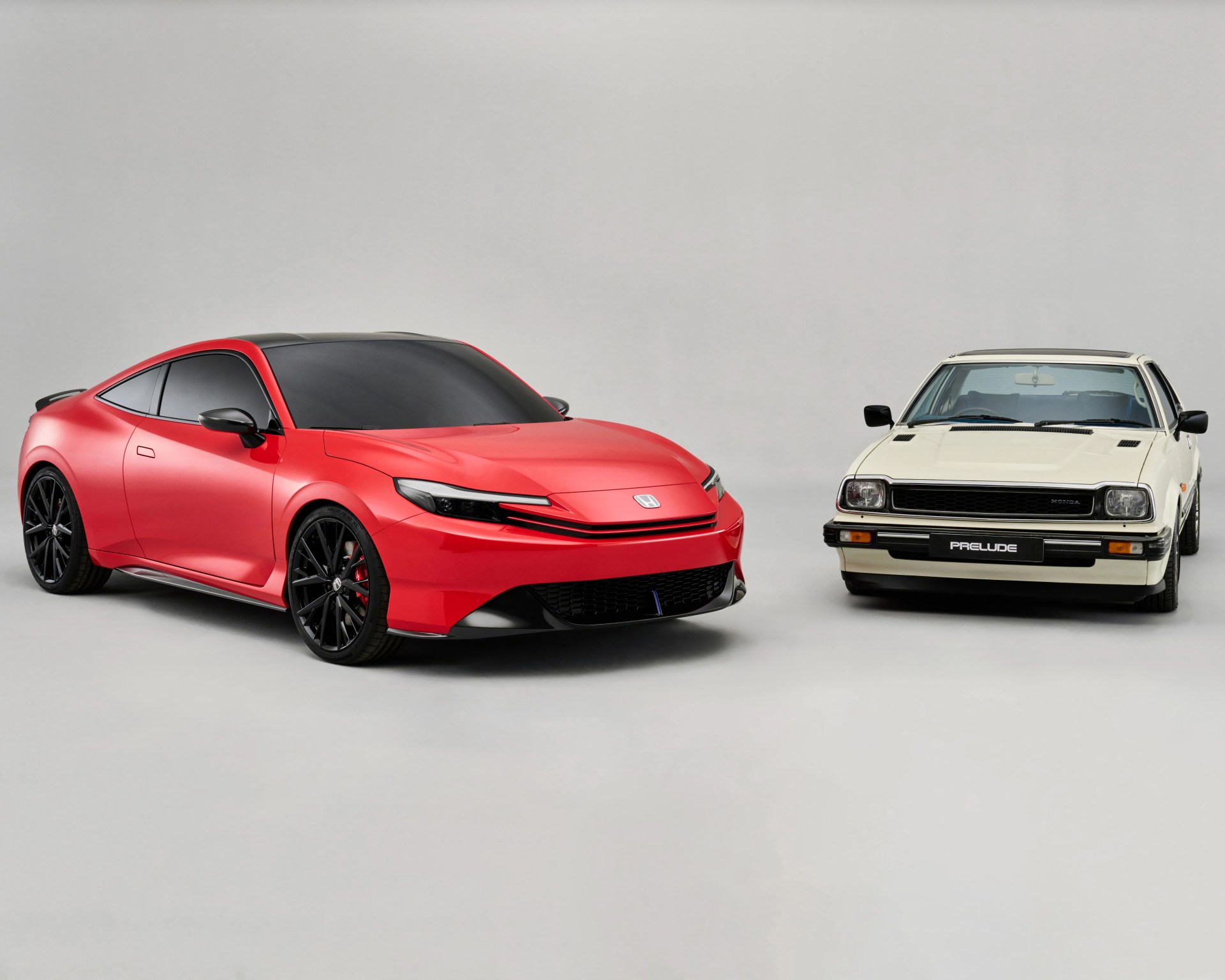 a shot of the sixth-generation Honda prelude next to the first-generation prelude