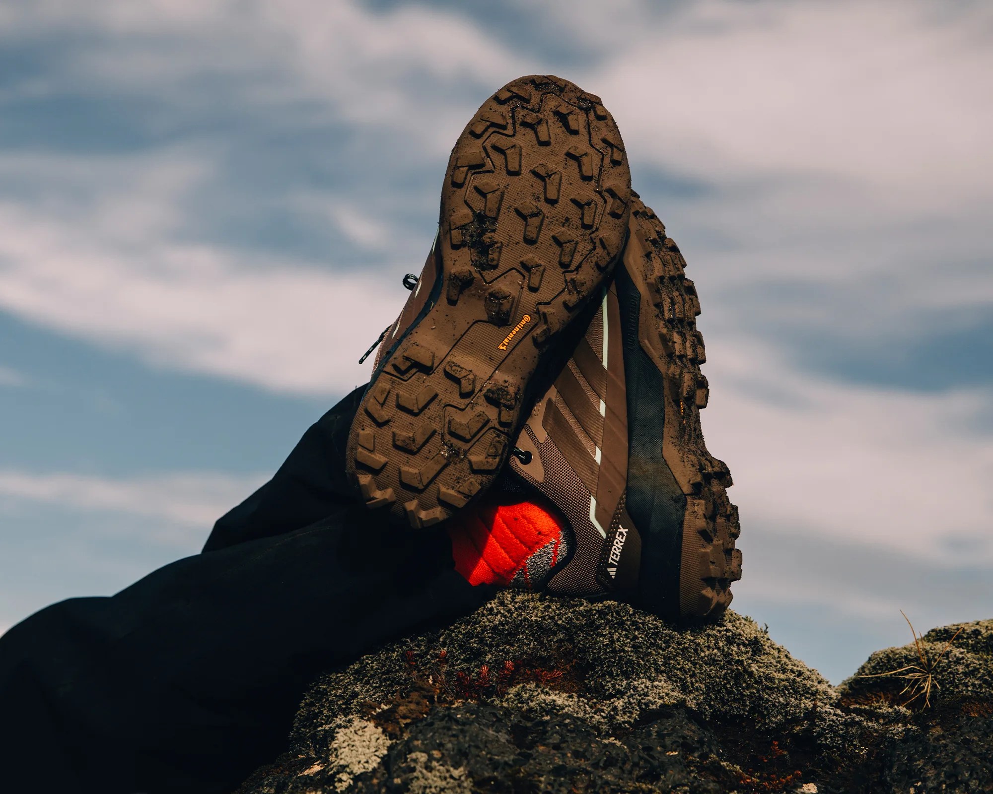 Adidas Skychaser AX5 Gore Tex Hiking Shoe worn by hiker kicking their feet up on a mossy rock
