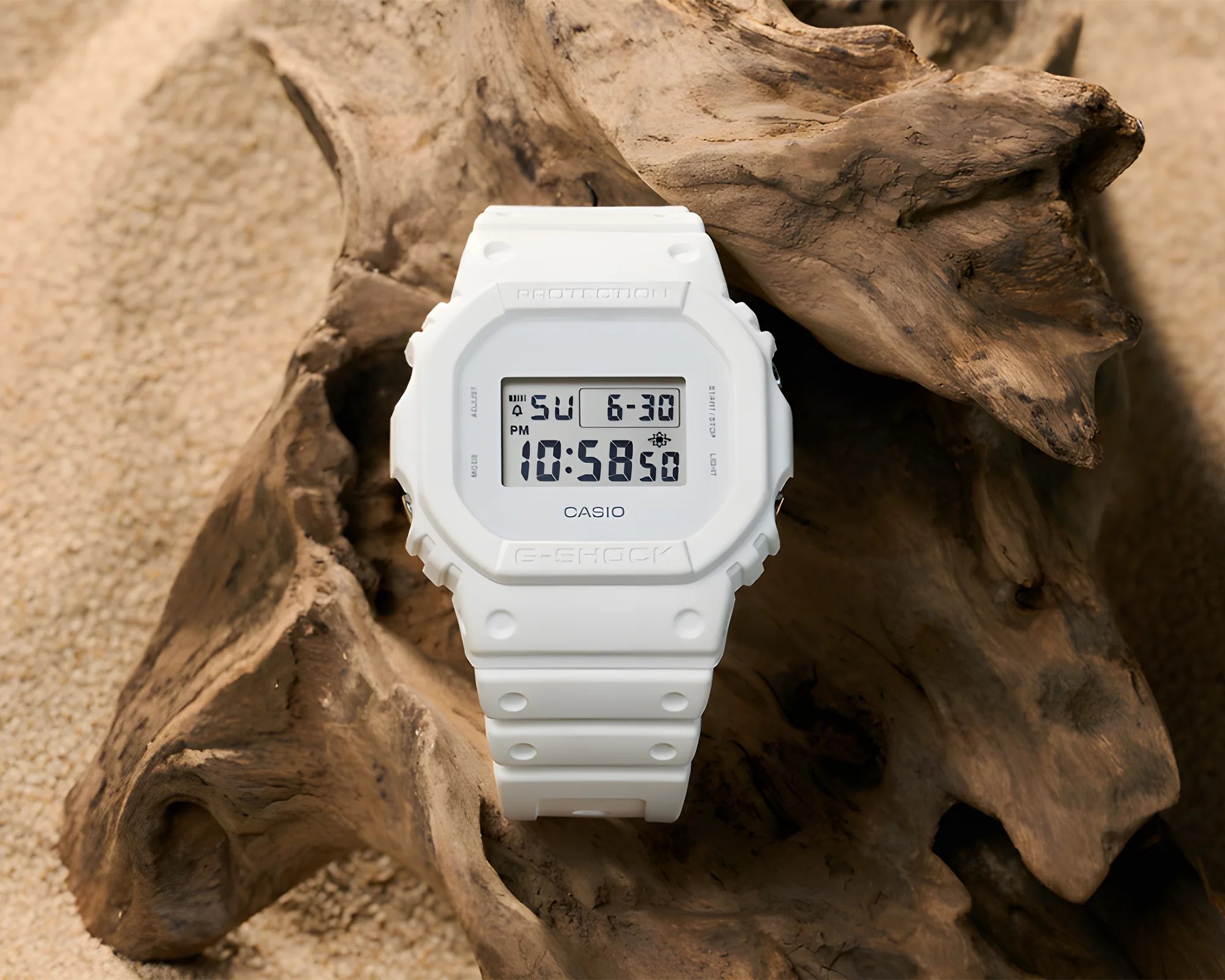 G-Shock 5600 Series DW5600WW-7 Watch on wood on sand