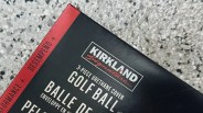 A close-up of the corner of a box of Kirkland signature golf balls