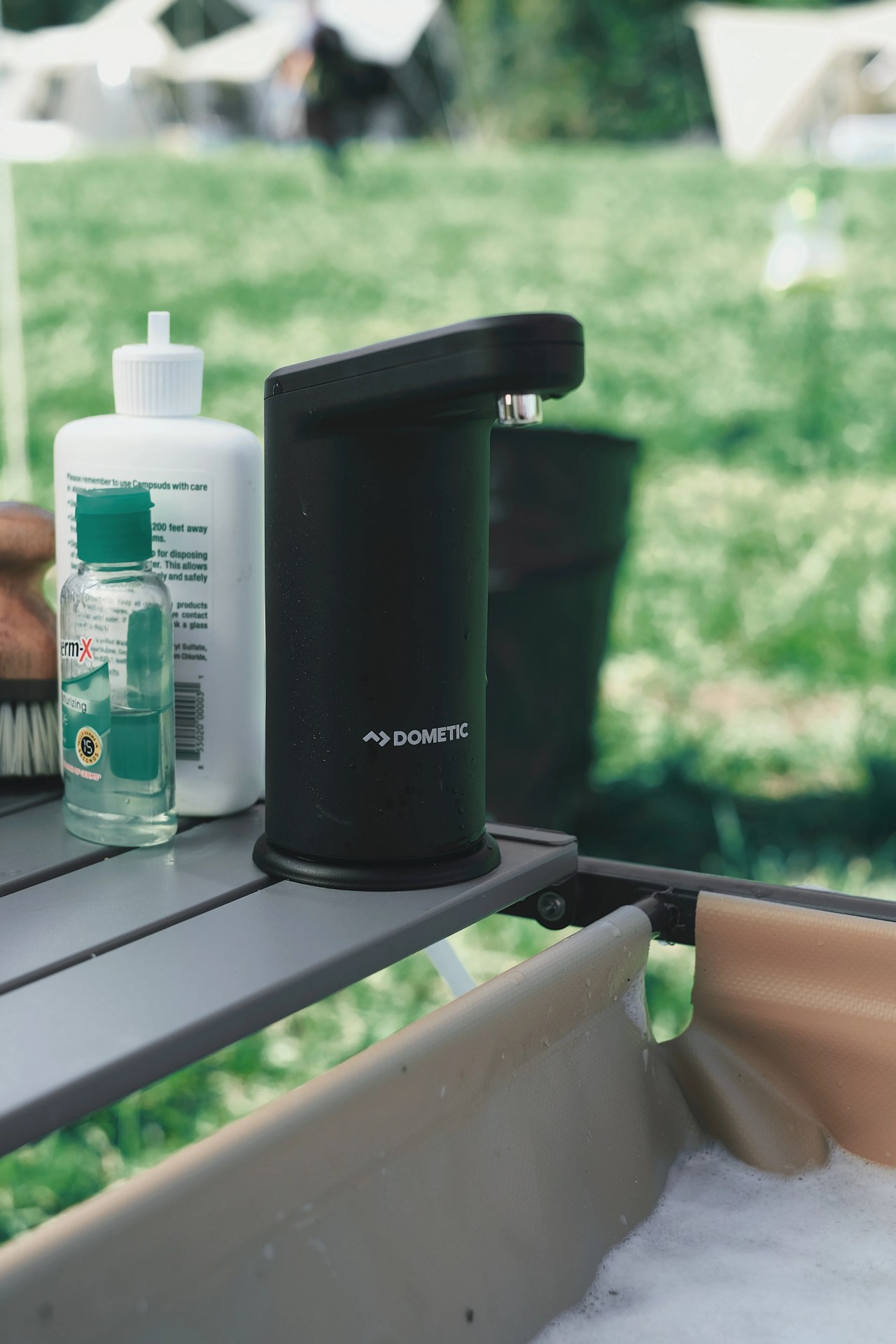 Dometic Go Hydration Water Faucet shown attached next to a camp sink