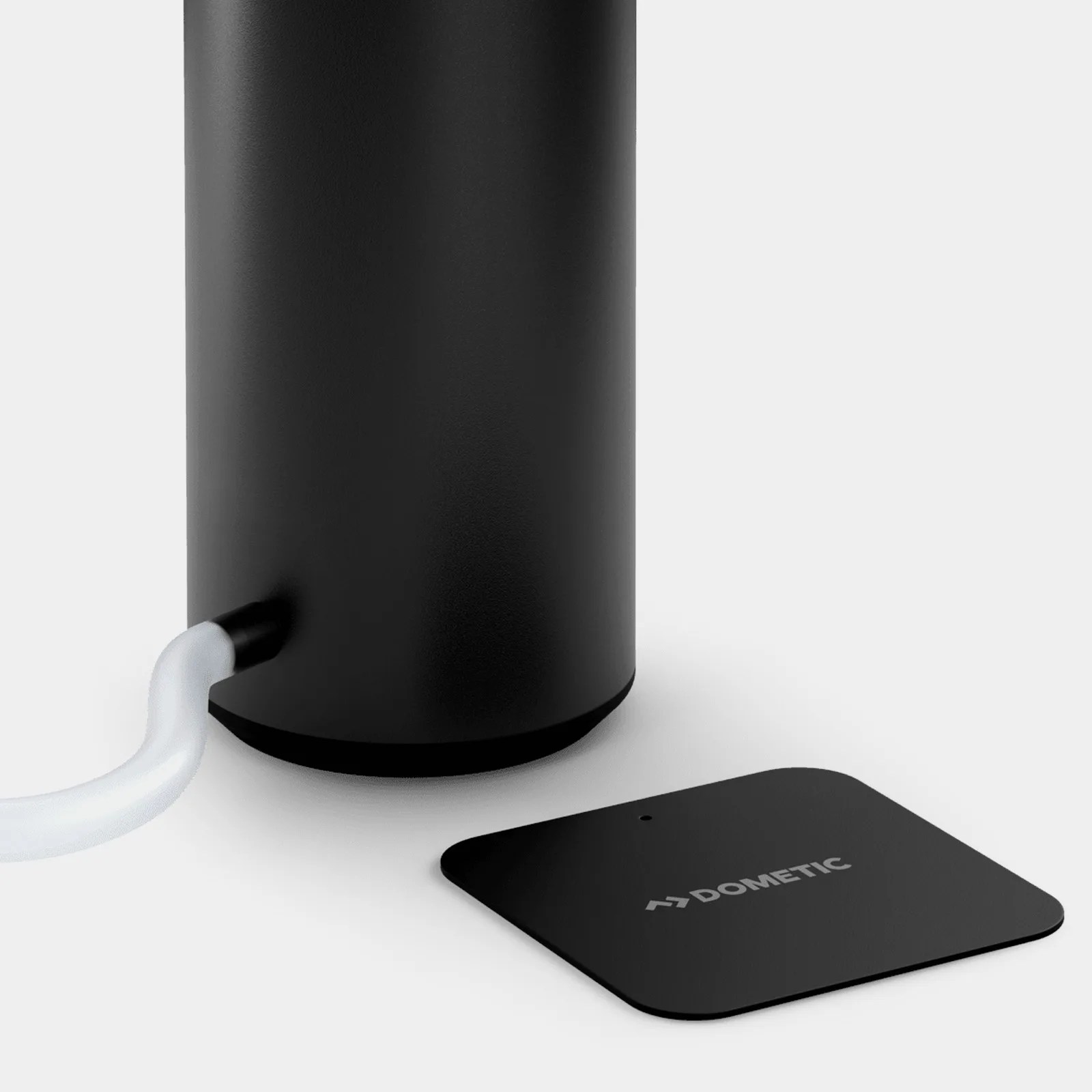 The base of the Dometic Go Faucet next to its included metal baseplate