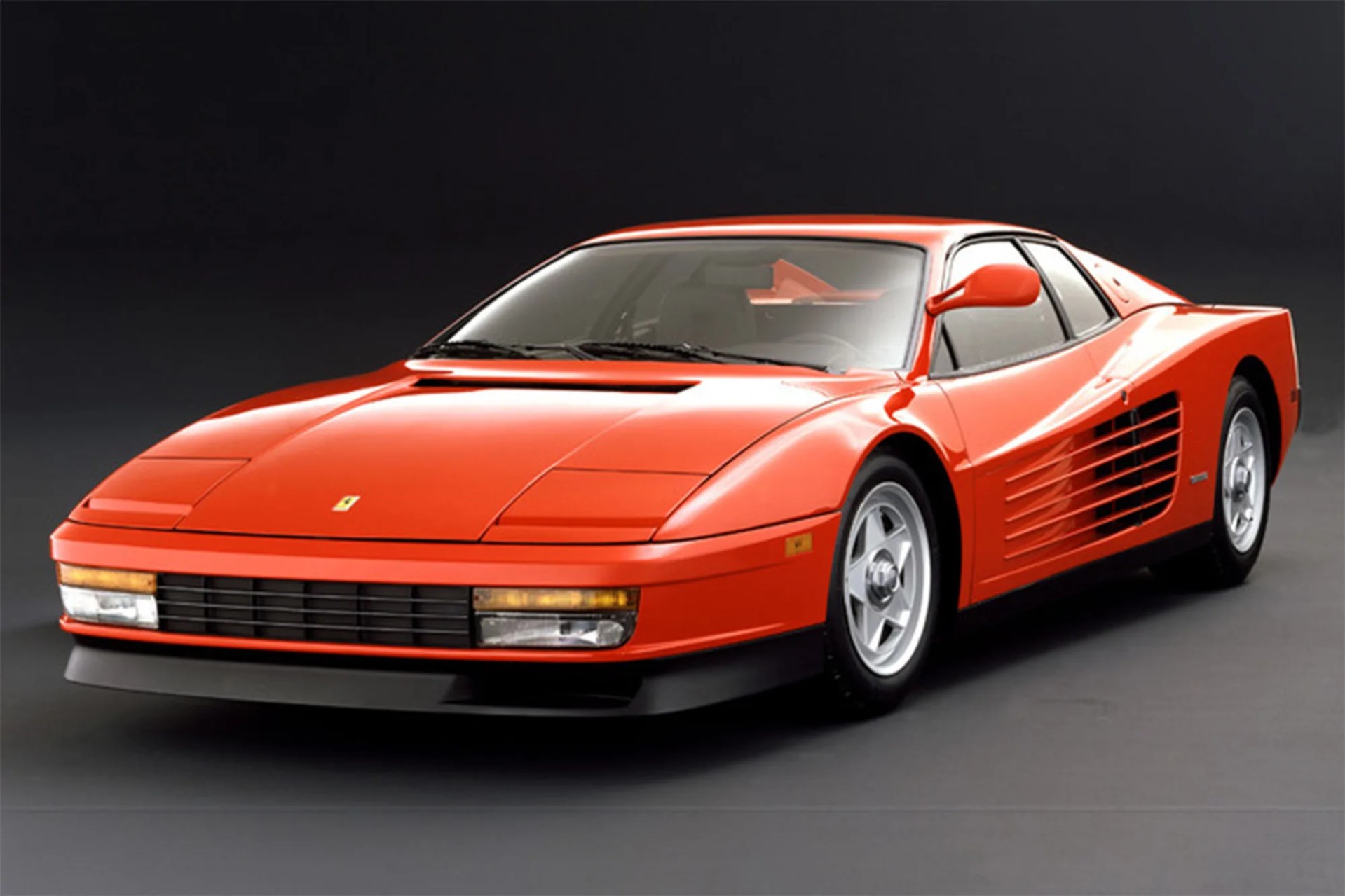 photo of Ferrari testarossa on studio backdrop