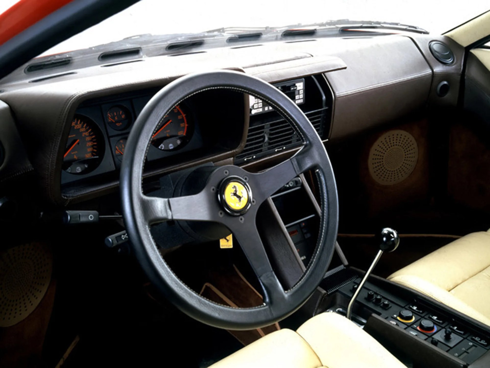 photo showing interior of ferrari testarossa with steering wheel