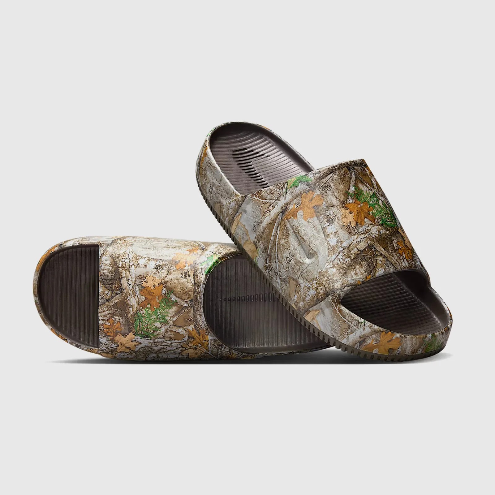 A pair of Nike Calm RealTree slides