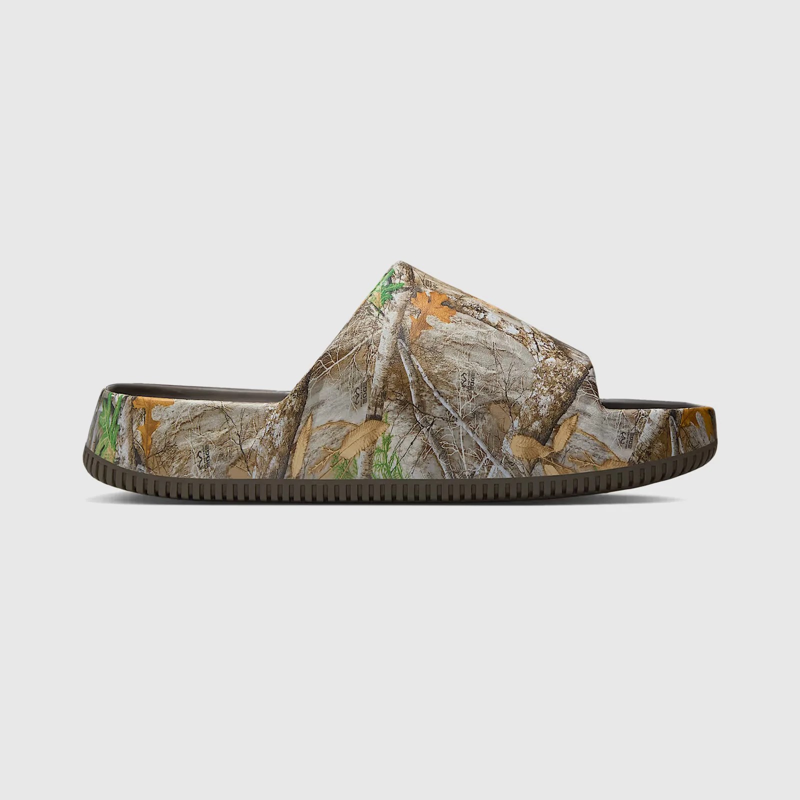 A profile view of the Nike Calm slide in Realtree