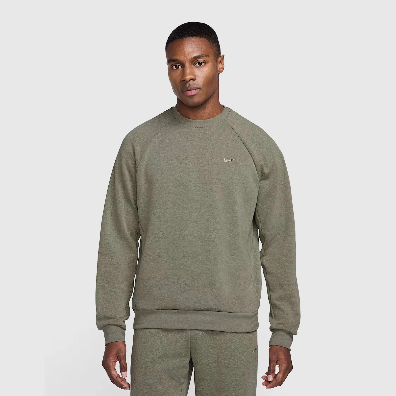 A male model wearing a army green sweatshirt