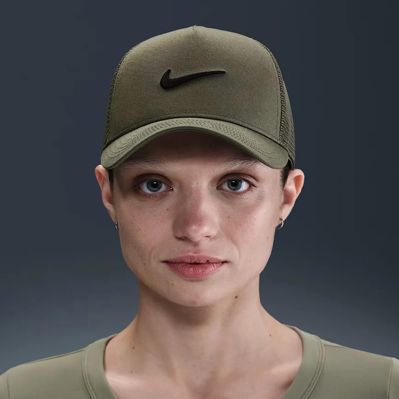 A female model shown wearing an army green NIke branded baseball cap