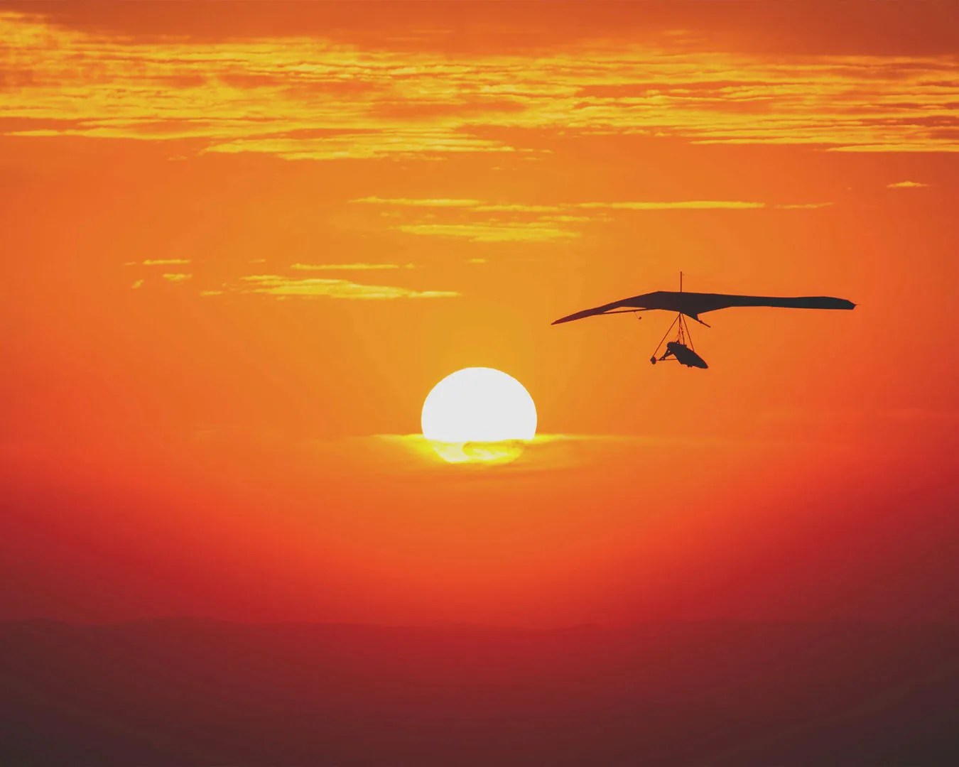 hang gliding at sunset