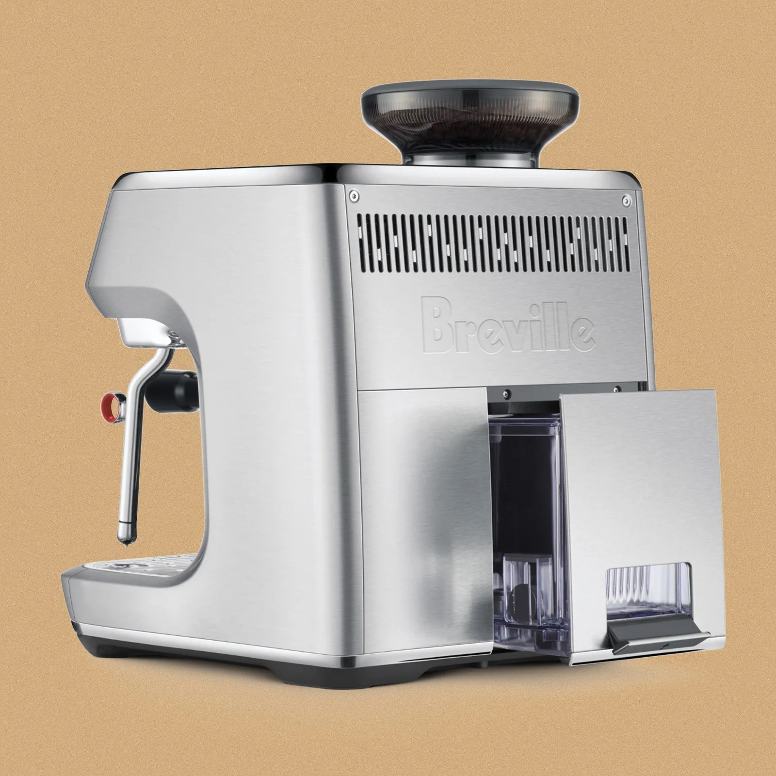 Stainless steel Breville espresso machine with a built-in grinder on top and a steam wand on the left side. The front panel features a partially open compartment revealing a transparent container inside. The machine has a modern, sleek design with ventilation slits above the Breville logo.