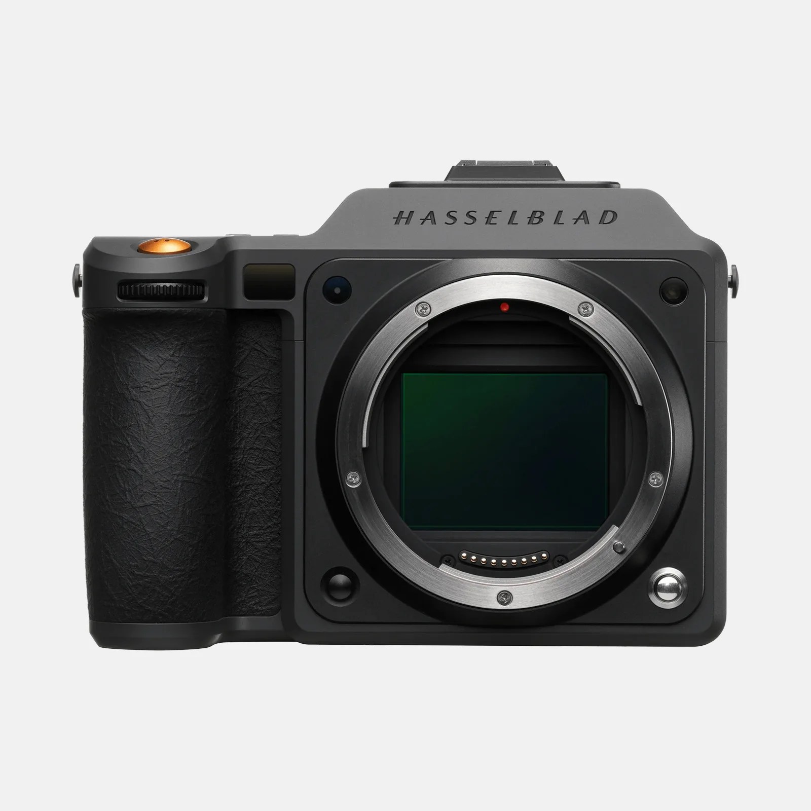 Hasselblad medium format camera body in black with a textured grip on the left side, a prominent lens mount in the center showing the sensor, and the brand name "HASSELBLAD" engraved on the top front. The camera has a sleek, modern design with a metallic shutter button on the right side of the lens mount and an orange shutter release button on the top left.