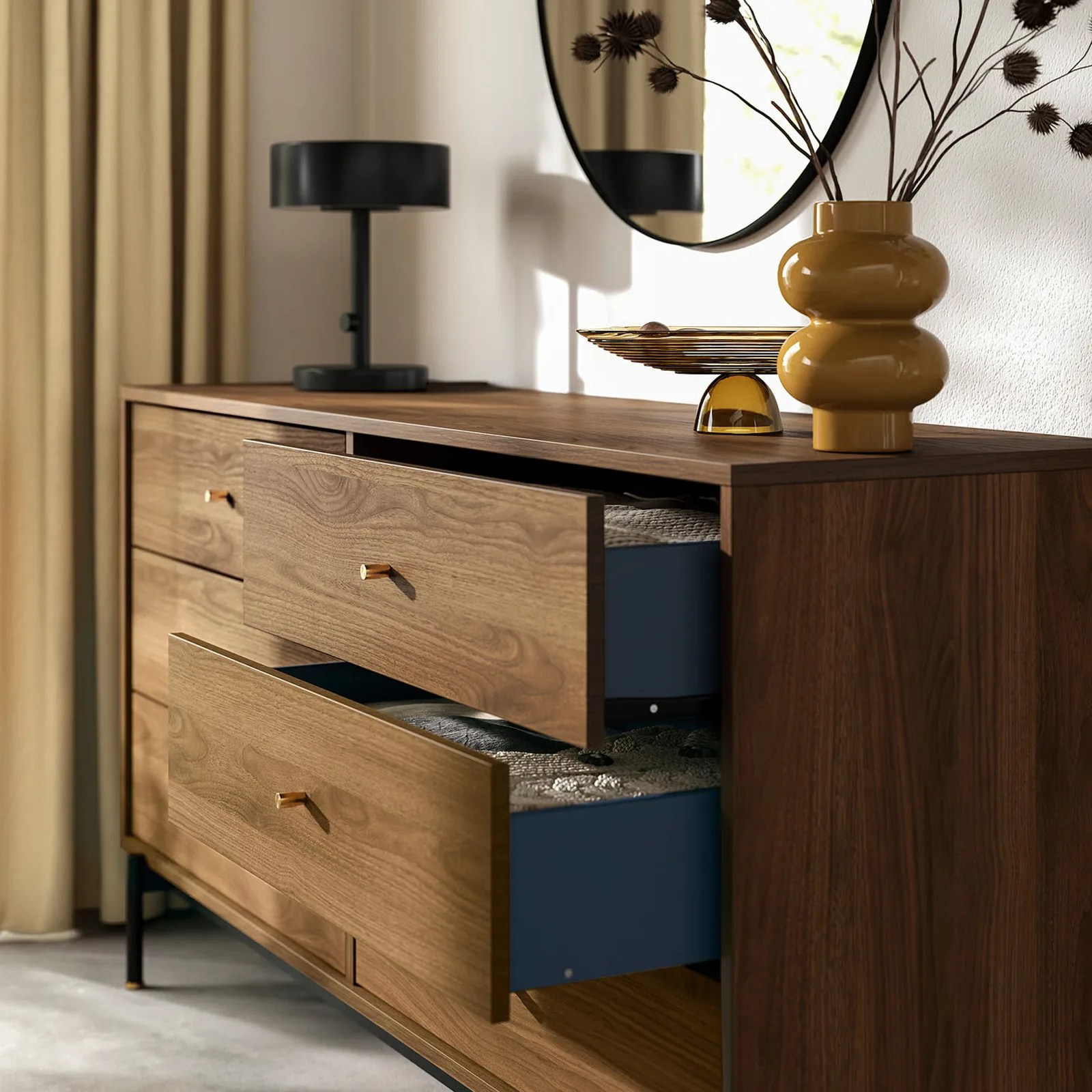 The IKEA RADMANSO six drawer dresser shown at an angle with the top two drawers on the right hand side pulled slightly open.