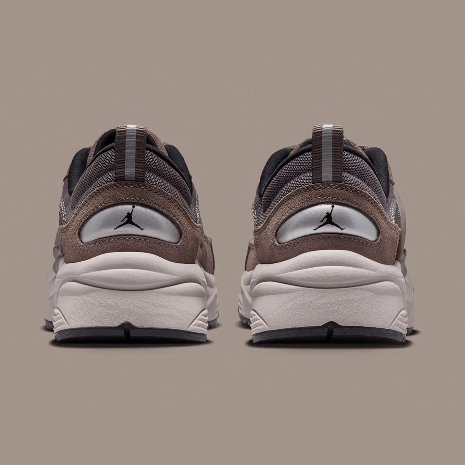 A pair of Jordan Trunner O/S Sneakers shown with the heels facing directly forward against a taupe background